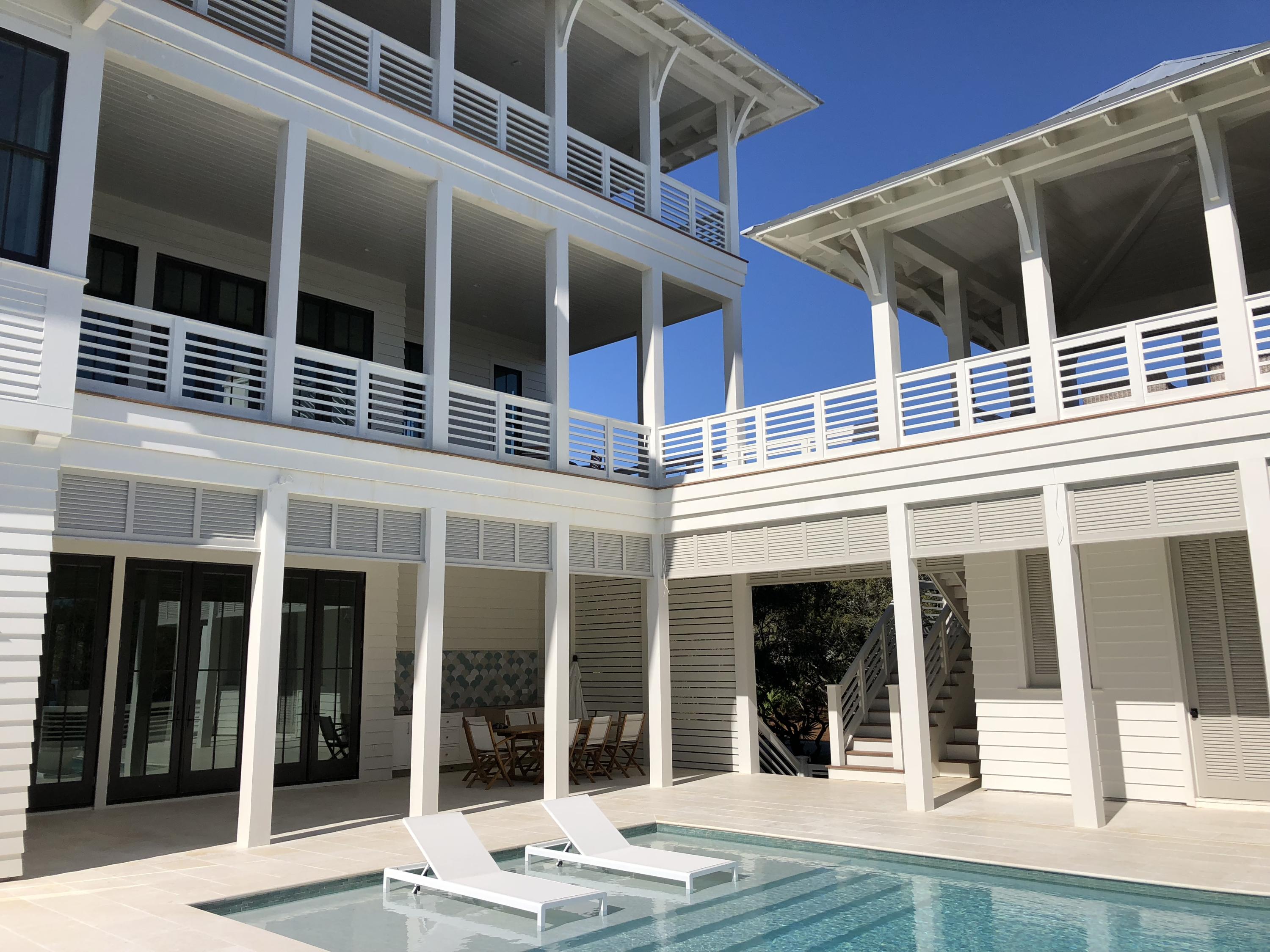 This striking home built by Coastal Elements construction showcases unparalleled outdoor living areas, beautiful interiors and privacy only found in Bannerman Beach Estates. As you drive through the gates into Bannerman Beach Estates, you instantly feel hidden from the rest of 30A. Guests are welcomed into the first floor by a large entertaining room complete with a wet bar area showcasing beautiful tile work from Q-Tile. Two guests suites and a third multiuse room complete the interior of the ground floor along with an additional full bathroom and large laundry room. Outside you find an expansive pool deck with a large infinity edge pool, summer kitchen, lounge area and sitting area circling a gas fire bowl. The pool house has its own full bathroom perfect for rinsing the sand off after a day at the beach. Climb the custom stairs to the second floor where you find the main floor dining and living area flowing into the beautiful kitchen and breakfast nook. The Venetian plaster walls and ceilings on this floor and throughout the home give the home a slightly contemporary feel. The sun room is connected to the main living area by a two sided gas fireplace.  Enjoy expansive gulf views from each of these rooms on the main floor.  The second floor outdoor perch complete with a gas fireplace extends out from the main house and has 180 degrees of gulf views. The third floor is the owner's retreat with a large master bedroom with Venetian plaster walls covered in windows looking out towards the gulf. Two additional bedroom suites are located on this floor which are currently being utilized as a gym and home office. Enjoy gulf views to the east, south and west from the third floor porch.  The carriage house operates as a separate living quarters complete with full bathroom and kitchenette. This impressive home is perfect for the person who enjoys all the 30A area has to offer, but wants the privacy of the most exclusive neighborhood in the area.