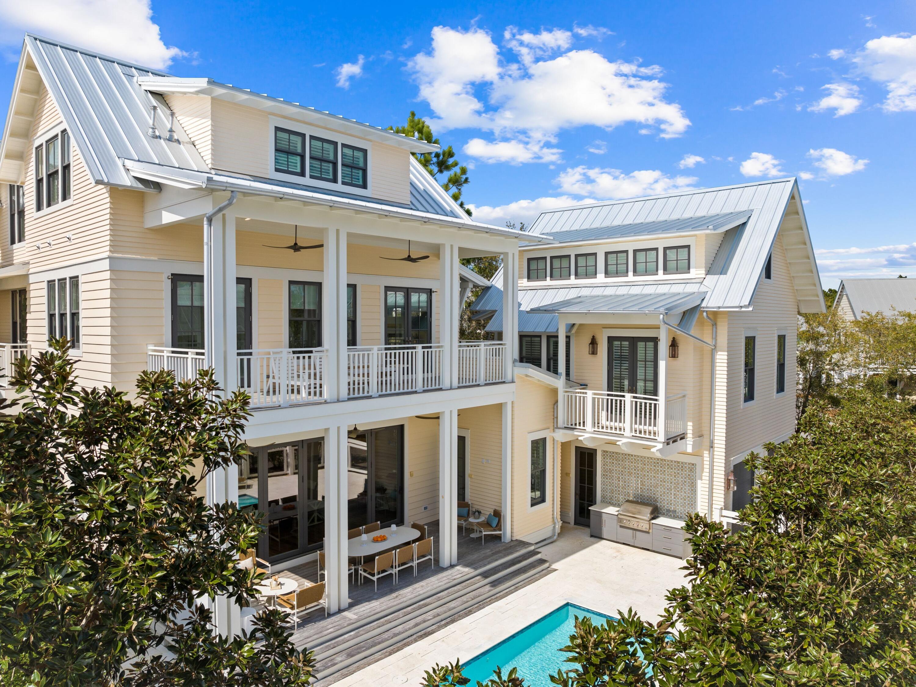 Unparalleled luxury and sophistication converge in this stunning seven-bedroom residence, nestled on a more spacious than usual corner lot in WaterColor's coveted Lake District. Designed by Stackable & Squires and expertly crafted by Cole Construction, this magnificent home boasts over 6,000 square feet of meticulously curated living space, exuding elegance at every turn. Step inside to be greeted by the grandeur of 200-year-old circle barn wood floors that flow seamlessly throughout the home, setting the stage for a truly enchanting living experience. The main level features a spacious foyer leading to the first-floor master suite, a cozy sitting area, and a stylish half bath adorned with a pecky cypress barn door. The heart of the home is the open living area, where a gas fireplace adds warmth and ambiance, while a NanaWall seamlessly connects the indoor and outdoor living spaces, leading to the private pool and hot tub.

The gourmet kitchen is a chef's delight, boasting driftwood granite countertops, inset cabinetry with an old-world finish, and top-of-the-line Wolf and Sub-Zero appliances. A large walk-in pantry ensures ample storage, while a wet bar adds a touch of sophistication to the space.

Upstairs, three generously sized bedrooms, each with its own ensuite bath, await, along with the grand master suite, featuring a spectacular master bath and a private balcony overlooking the pool. The third floor is a haven for the young and young at heart, with a large game room and a massive bunk room connected by dual Jack-and-Jill baths.

The whimsically designed carriage house offers additional living space, perfect for guests or as a separate rental opportunity, with a bedroom downstairs and a loft area upstairs, complete with a full kitchen and bath.

Outside, the expansive covered deck and heated pool provide the perfect setting for outdoor entertaining, while lush landscaping adds to the ambiance of this serene retreat. With state-of-the-art amenities, including grasscloth wallpaper, plantation shutters and hand-hewn beams, this home offers a perfect blend of luxury and comfort.

WaterColor is known for its world-class amenities including resort pools, Camp WaterColor, acres of gardens and trails, and an exclusive beach club. From the residence to the lifestyle, every detail has been thoughtfully curated to create the ultimate in coastal living.