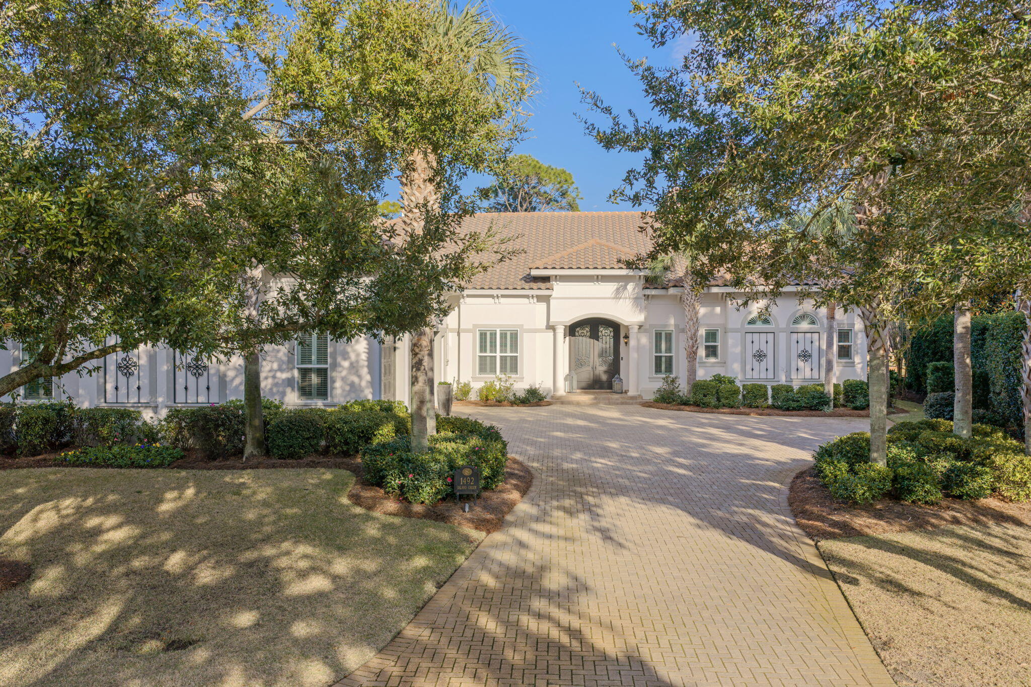 An entertainer's dream set along the 16th fairway of the Raven Golf Course, this beautifully updated residence is nestled within the quiet, non-rental enclave of Island Green. Thoughtfully refreshed with fresh interior paint, new drapery, and designer lighting—including chandeliers and sconces throughout—the home blends timeless elegance with modern comfort.

The heart of the home features an updated kitchen with new cabinet hardware, a brand-new refrigerator, walk-in pantry, and effortless flow into expansive living spaces complete with a wet bar and five-panel seamless windows. An accordion door opens to the screened-in lanai, creating a true indoor-outdoor living experience.

Outdoors, enjoy a private resort-style oasis with a heated saltwater pool, waterfall hot tub, outdoor kitchen, and gas fireplaceideal for year-round entertaining while overlooking the golf course. A newly installed backyard fence enhances privacy and functionality.

The main-level primary suite offers a luxurious retreat with his-and-hers closets and vanities, a double-access shower, tranquil views, and direct access to the screened lanai. A private study with built-in wood cabinetry, hardwood flooring, and a fireplace provides an elegant workspace or reading room.

Upstairs, new carpet complements two additional bedrooms, a kitchenette, media room, and balconyperfect for guests or extended stays. Storage is abundant throughout the home, and an oversized three-car garage adds exceptional convenience.

As part of the Sandestin Resort, owners enjoy unparalleled access just minutes away to pristine white-sand beaches, the marina, Baytowne Wharf, Grand Boulevard's premier shopping and dining, world-class golf and tennis, and the resort's aquatic center. Luxury updates, generous living spaces, and an unbeatable golf course setting make this home a rare opportunity in Island Green.