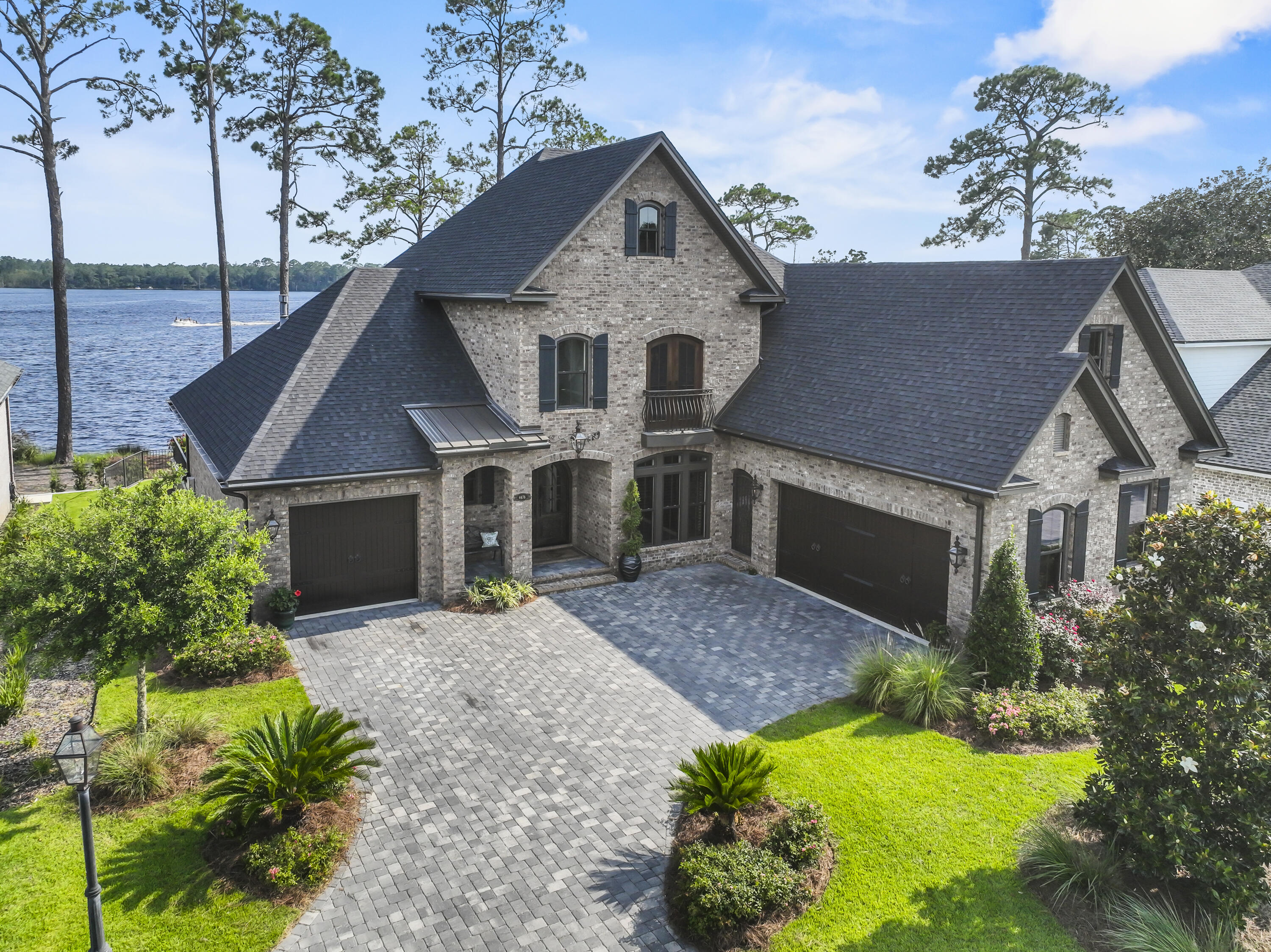 Majestic Waterfront Estate with custom impressive details and an open floor plan where relaxed living and southern hospitality flawlessly weave. Perfectly situated on Rocky Bayou's Aquatic Preserve, this home boasts a gorgeous pool with a spacious patio, pool bath, boat dock with lift, jet ski lift, pool table/rec room, gleaming hardwood flooring, and thoughtful details in every room. Covered porch offers a shady place to unwind and enjoy year-round sunsets. Lush landscaped grounds. Two extra-large two car garages  allow room for your leisure vehicle. Inside, a grand foyer opens to a beautiful custom 18ft ceiling where the office has a custom floor-to-ceiling brick wall. Gorgeous water views are the star of the show and are maximized by the large windows and porch access from the living room, kitchen, and dining. The spacious living room offers surround sound, a gas fireplace, and gorgeous water views. A gourmet kitchen features an extra-large island, gas range, double ovens, bar with seating for six, a walk-in pantry, ice maker, wine fridge, coffee station and so much more. The first-floor primary suite is a serene escape with a large bathroom with built in vanity, and a large closet with convenient access to the laundry room. An office, bedroom suite, laundry room, half bath and powder bath off the living room are also on the main level. Everyone gathers in the second level game room for pool and revelry after a day on the water. Two bedrooms with a full bathroom ensure privacy and comfort, while the large den holds endless possibilities. The massive amounts of foam insulated storage in this home is a must see. This home tucked at the end of Rocky Bayou for added protection is in elite company with very few Bayou homes that enjoy year-round sunsets, coupled with estate-sized living. All outdoor furniture covey with the sale. Please call for your private showing today.  Buyer to verify measurements and everything deemed important.
