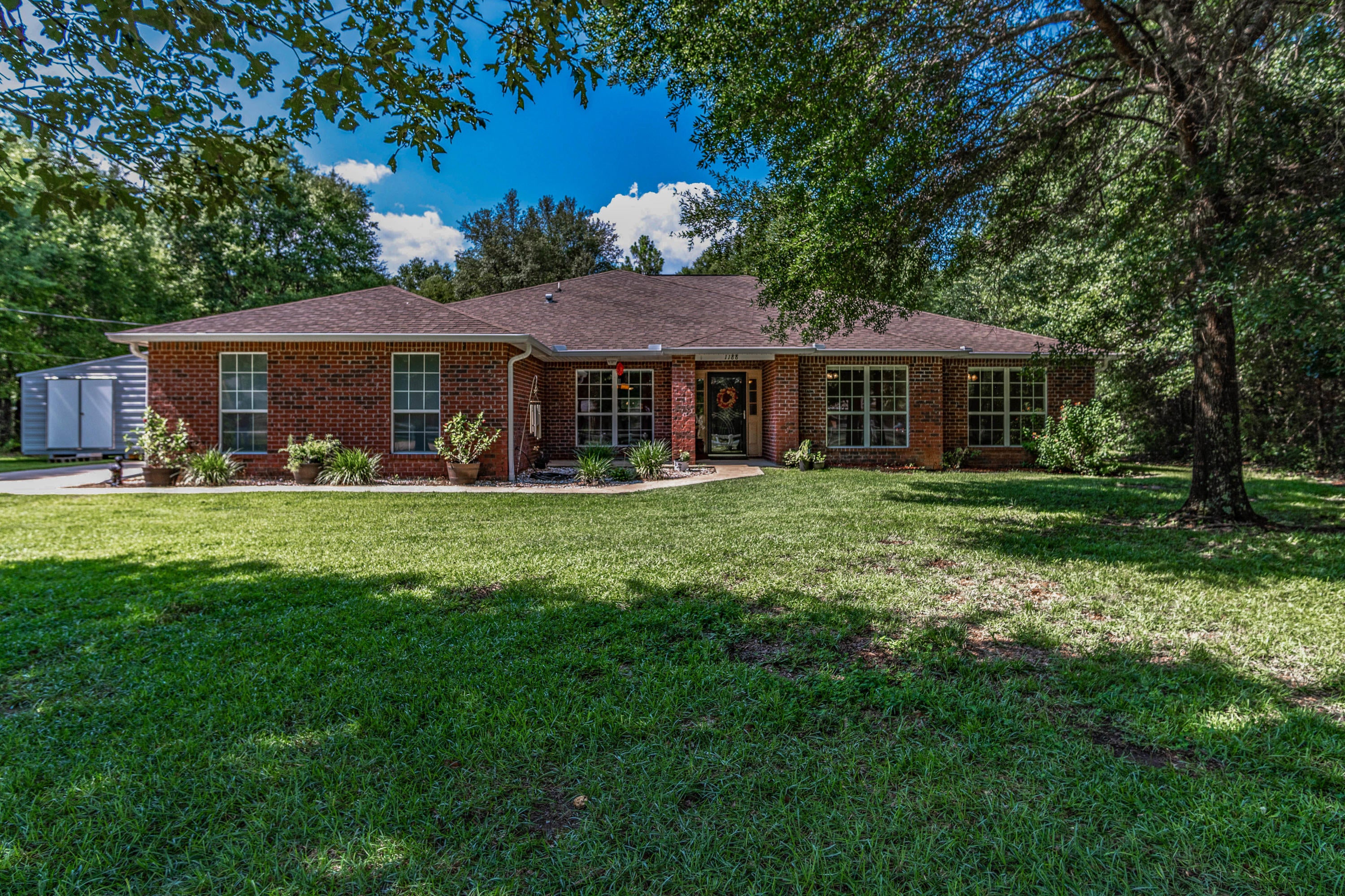 You will absolutely fall in love with this beautiful 4/2, 2577s/f, all brick home on a 0NE ACRE parcel. The very spacious (17.4 x 18.6) master suite features a large master bath with soaking tub, separate shower, two vanities and his and her walk-in closets. Sliding glass door leads out to the screened lanai, overlooking a very private back yard. The large eat-in kitchen has a bay window and an island. All appliances convey. In addition to the 4 bedrooms, there is a designated Den/Study and a large dining room. There are too many features to list. A floor plan is in the document section. Call today to see this one for yourself. Homeowner has also added a storage unit with a carport.