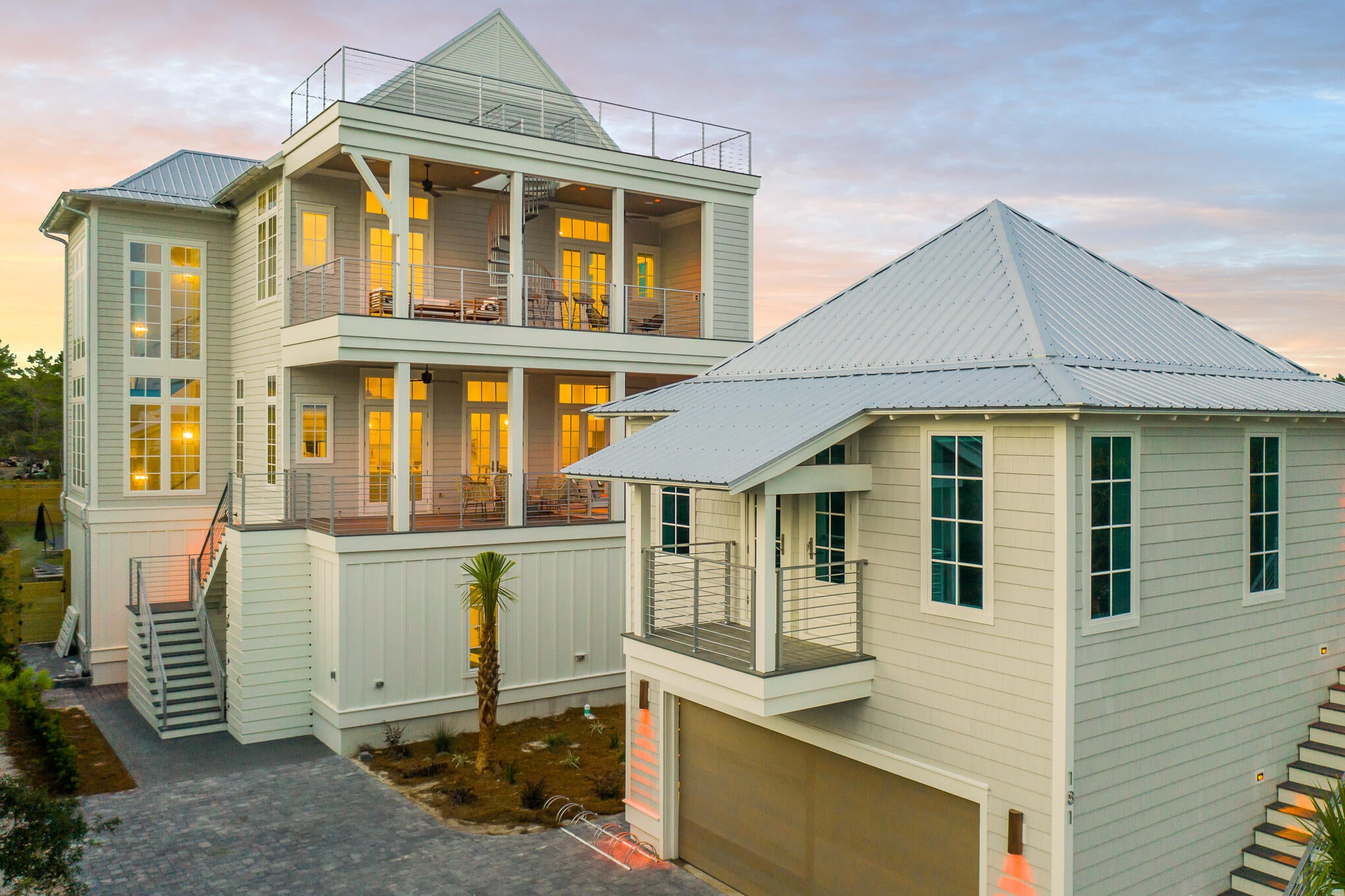 Experience the ultimate vacation experience in this uniquely designed beach sanctuary! Incredible gulf views from both the second, third, and forth floors of the property offer the opportunity to enjoy the beautiful emerald waters right from your own porch. Astounding architecture paired with a flawlessly planned floorplan create space for large gatherings of families and friends to experience a true 30A retreat. Features of the property include a grand great room with dining for the entire party, a breath-taking 4th level sky deck, a huge private resort-style pool, incredible outdoor living, a separate detached carriage house, parking for over eight vehicles and much more. 
Step into the first floor of the property to find a space created for the kids in the family as well as the young at heart. This floor contains a separate kid's living area which includes space for a large TV, huge sectional, pool table, and additional gaming space. The recreation room seamlessly lives with the outdoor entertaining area boasting a large resort-style pool. Additionally on the ground level, there are 2 large bunk rooms, each sleeping 10. Each bunk room has its own locker room style bathroom boasting a large triple vanity and 2 shower stalls in each. The first laundry room can also be found here off the living area.

As you climb to the second floor you will be welcomed by the amazing gulf views and bright sunlight in the grand stairwell. This floor holds the main living space as well as a huge dining area offering room for the entire family to gather for dinner. You will find a wet bar containing a bar sink, under-counter fridge and ice machine off the dining for convenient access. From the dining space move across the open concept to the amazing chef's kitchen. The kitchen boasts a built in 36" Sub-Zero fridge, built-in 36" Sub-Zero freezer, 48" Wolf gas range, a custom range hood, 2 dishwashers and a microwave drawer. No amenities were missed in this kitchen! The huge living space is located across from the kitchen and offers a wonderful area for the family to enjoy time together. Furthermore on this floor, you will locate 2 king suites, each with private bathrooms and balconies overlooking the pool.

The third floor of the property showcases the astonishing master suite, 2 additional junior suites and a third bunk room. The master bedroom and bathroom each boasts a private balcony offering breath-taking views of the gulf, a large walk-in shower, free-standing tub, and separate vanities. On this level, you will also find the second full size laundry room here for easy access to all guests. Two additional full sized bathrooms are located on this level.

Away from the main house, you will discover a separate detached carriage house. The carriage house offers its own private kitchen, laundry, bedroom, bath and living. This private space offers flexibility when large parties stay at the home. The first floor of the carriage house contains the 2 car garage. This space is perfect for not only parking but also storing all those necessary beach items!

The outdoor living space at 181 Eastern Lake is incomparable! With beach access only steps from the front door you will be enjoying the white sand and emerald waters within minutes from leaving the house. Back at the property, the pool offers a huge spa, sun-deck for sun-tanning, and a pool TV for watching while swimming! You have never experienced a pool like this before! In addition, right off the pool you will find an amazing outdoor kitchen with large gas grill, fridge and sink. There is also a private outdoor shower off the back of the main house for after beach showers. Additional outdoor recreational space can be found behind the property. A large privacy fence borders the entire outdoor space. Finally in addition to the garage space, the property offers parking for at least an additional 6 vehicles.

Features of the property include an elevator; white oak hardwoods throughout; marble in many of the bathrooms; unique wood on the great room ceiling; quartitze countertops in the kitchen; beautiful lighting; incredible plumbing fixtures; amazing tile on the back-splashes and bathrooms; 3 tankless hot water systems; a metal roof; and much more! The property offers sleeping for 36 in beds with an additional 6 in queen size pull outs, for a total of 40. A full listing of the property specs is available upon request. Do not miss your opportunity to own the ultimate vacation rental, you will not find another property like this in our area!

*Finished photos are the same floor-plan built in another location.
