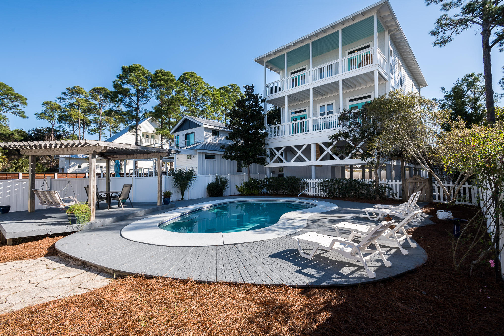 PRICE REDUCED BY $150 K! Florida cottage with Caribbean flair on highly desirable, low traffic Magnolia Street. Custom design, quality construction features 2 Master BR's, Bunk room, 10' ceilings, crown molding, hardwood floors throughout. Expansive covered porches on 2nd & 3rd levels overlook large back yard with sizable pool, patio/sun deck. Exterior compliments include Bahama shutters, picket and privacy fencing surrounding entire lot. Natural, low-maintenance landscaping and plenty of storage, covered and driveway parking. Truly a classic family beach house that has only been utilized by current owners since 2002-never rented- but has tremendous rental potential. Easy stroll to 2 beach accesses to undisputed, state-owned, world-famous Grayton Beach. New metal roof February 2024.