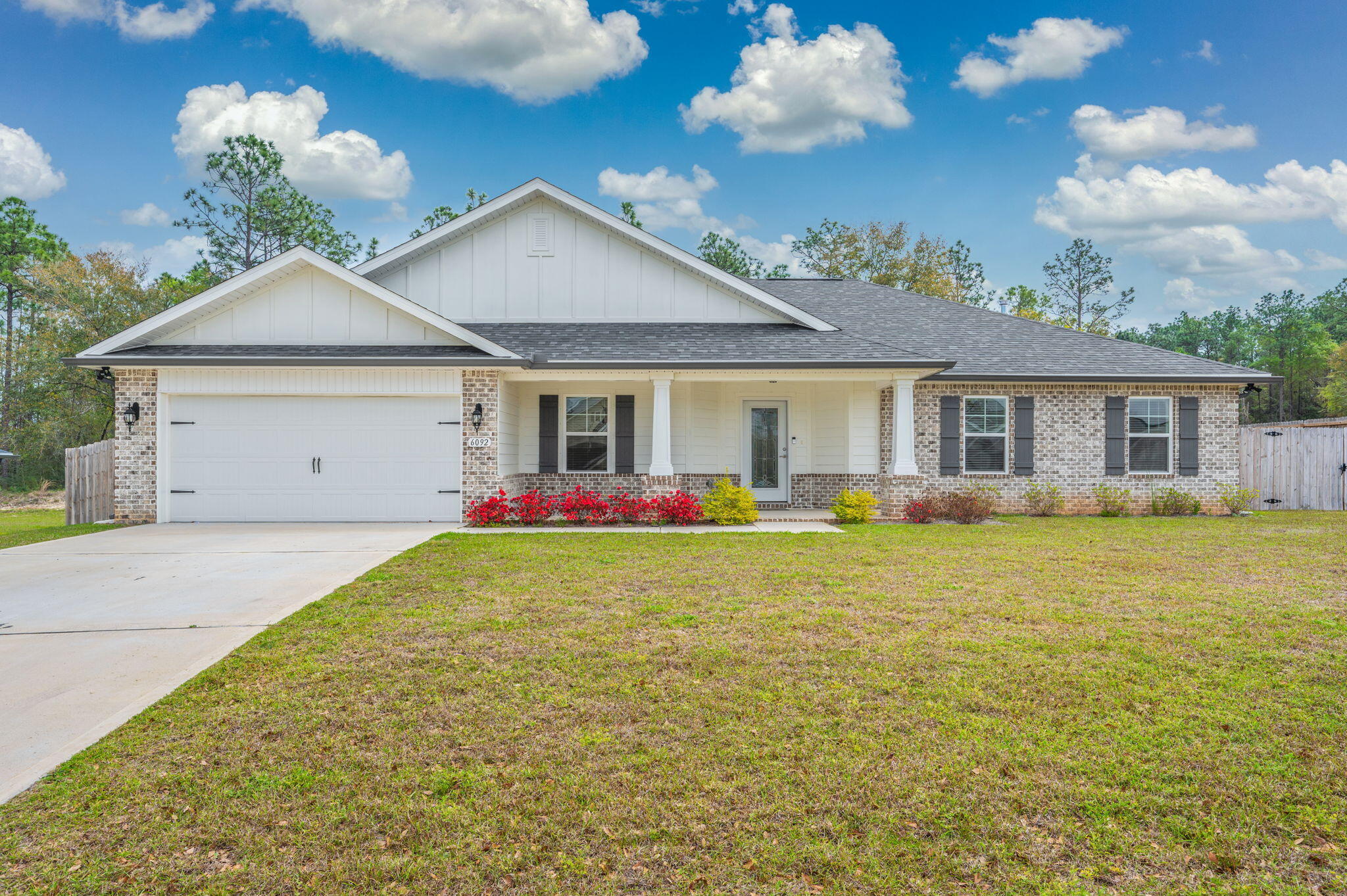 SELLER OFFERING $5,000 CLOSING COST MONEY.  Built with durable 2x6 exterior wall construction, this thoughtfully designed split-bedroom floor plan offers 3 bedrooms, 2 baths, and a 2-car garage. Inside, you'll find a spacious family room, dining area, and a versatile bonus room--perfect for a home office or flex space. Enjoy laminate wood plank flooring throughout, with tile in all bathrooms. The kitchen is beautifully appointed with granite countertops, a center island, and stainless steel appliances. The primary suite is a true retreat, featuring a signature zero-entry, all-tile walk-in shower with dual shower heads, a separate soaking tub, granite double vanities, tile flooring, and a large walk-in closet. Additional features include ceiling fans, a covered rear lanai, Sprinkler Sys. Additional features include ceiling fans in the main living area and all bedrooms,or outdoor living, and a full irrigation system.