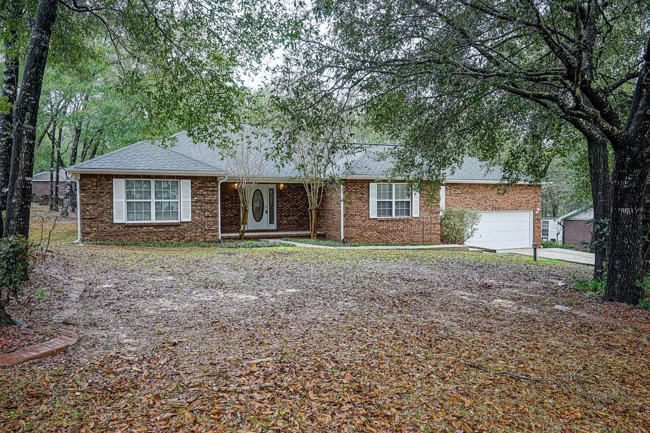 Great mostly brick home sits on a half acre  for that country feeling close to town.  Ceiling treatments and arches throughout add to the architectural appeal. Large living room features a cathedral ceiling, gas fireplace, recessed lighting and leads to 18x11 screened porch. Super kitchen with abundant cabinet and counter space offers an island for food preparation, dual ovens, stainless appliances, solid surface counters and gas stove.  Split plan for private master suite. Master bath has large jetted tub, separate shower, double vanity, power room and large walk-in closet. New roof and hot water heater replaced this year. There's a 15x11 workshop/storage with double doors and a 10x12 covered deck. Long drive allows extra vehicle parking.  Don't miss this great home in a tranquil setting.