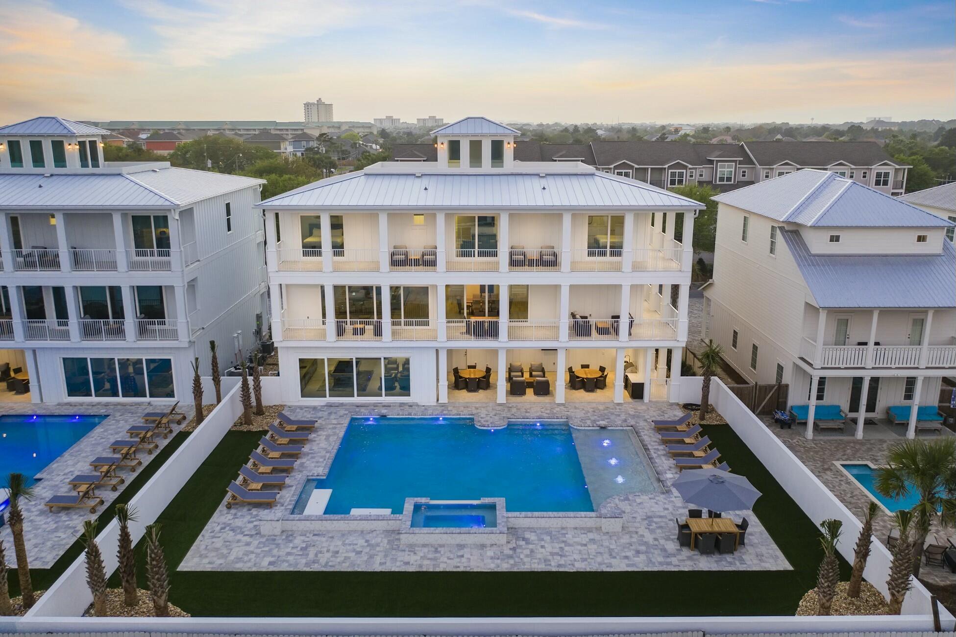 Welcome to Hypnautic — a luxury beach retreat spanning 6,650 square feet across three expansive levels, plus a fourth-floor rooftop observation deck with panoramic Gulf views.
Designed to impress and perform, this home comfortably accommodates up to 30 guests while offering parking for 10+ vehicles, making it ideal for large groups, events, and high-end short-term rentals. A short walk to the beach is complemented by an exceptional private resort setting at home.
The outdoor living experience rivals a boutique resort, featuring a heated pool and spa, in-pool concrete picnic table, Royal Teak furnishings, and a fully equipped outdoor kitchen—all surrounded by low-maintenance, lifelike synthetic turf for year-round beauty. Inside, expansive floor-to-ceiling sliding glass doors on the first and second levels create seamless indoor-outdoor living with a California-coastal feel. Entertainment is taken to the next level with a multi-level in-home movie theater, elevator, whole-home Sonos system, multiple arcade games, and pool table.
Thoughtfully engineered as a true high-performance rental, the home maximizes sleeping capacity without sacrificing quality or design. Offered fully furnished and rental-ready, this no-HOA property carries an estimated projected annual income of nearly $400,000.
Hypnautic isn't just a beach houseit's a turn-key luxury experience built to entertain, impress, and perform.