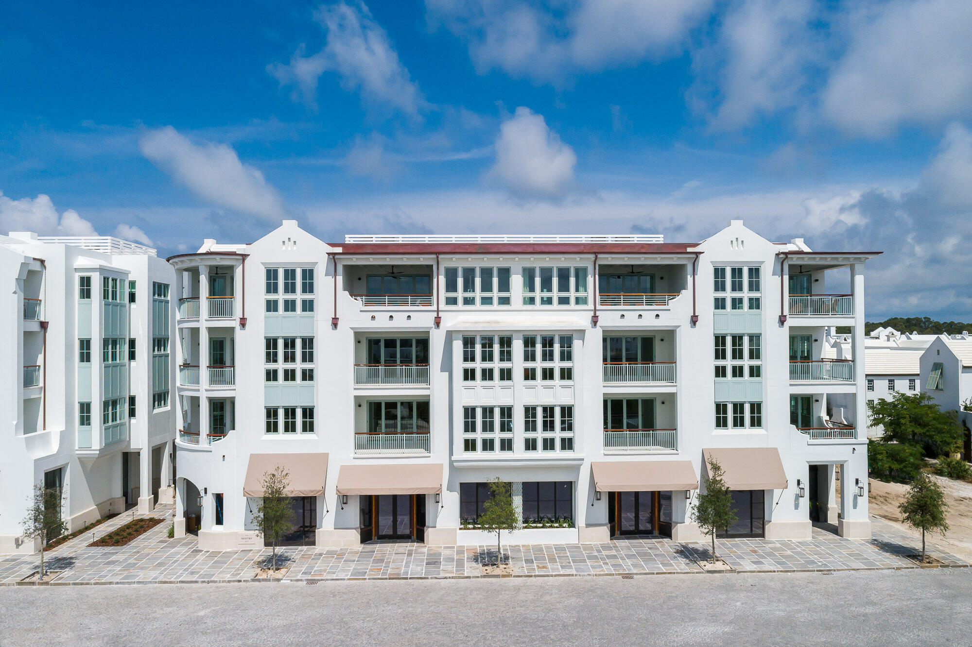 Enter for comp purposes.  Both the Camden and Whitby hold a new and prominent luxury residential location in the Town Center of Alys Beach, as well as offer unique retail experiences. Architectural cousins, related but unique, each building is expressive of its own distinct personality. The architecture of these new buildings borrow from the rich traditional vernacular of Bermuda and the sculptural plaster language evolving at Alys Beach and are seamlessly woven into the fabric of the Town Center. The architectural details comprised of retail steel windows, iron balconies, crafted tile and large openings add a touch of modernity to the traditional and familiar forms of the massing.
These residences were carefully crafted to take full advantage of the ampitheater.