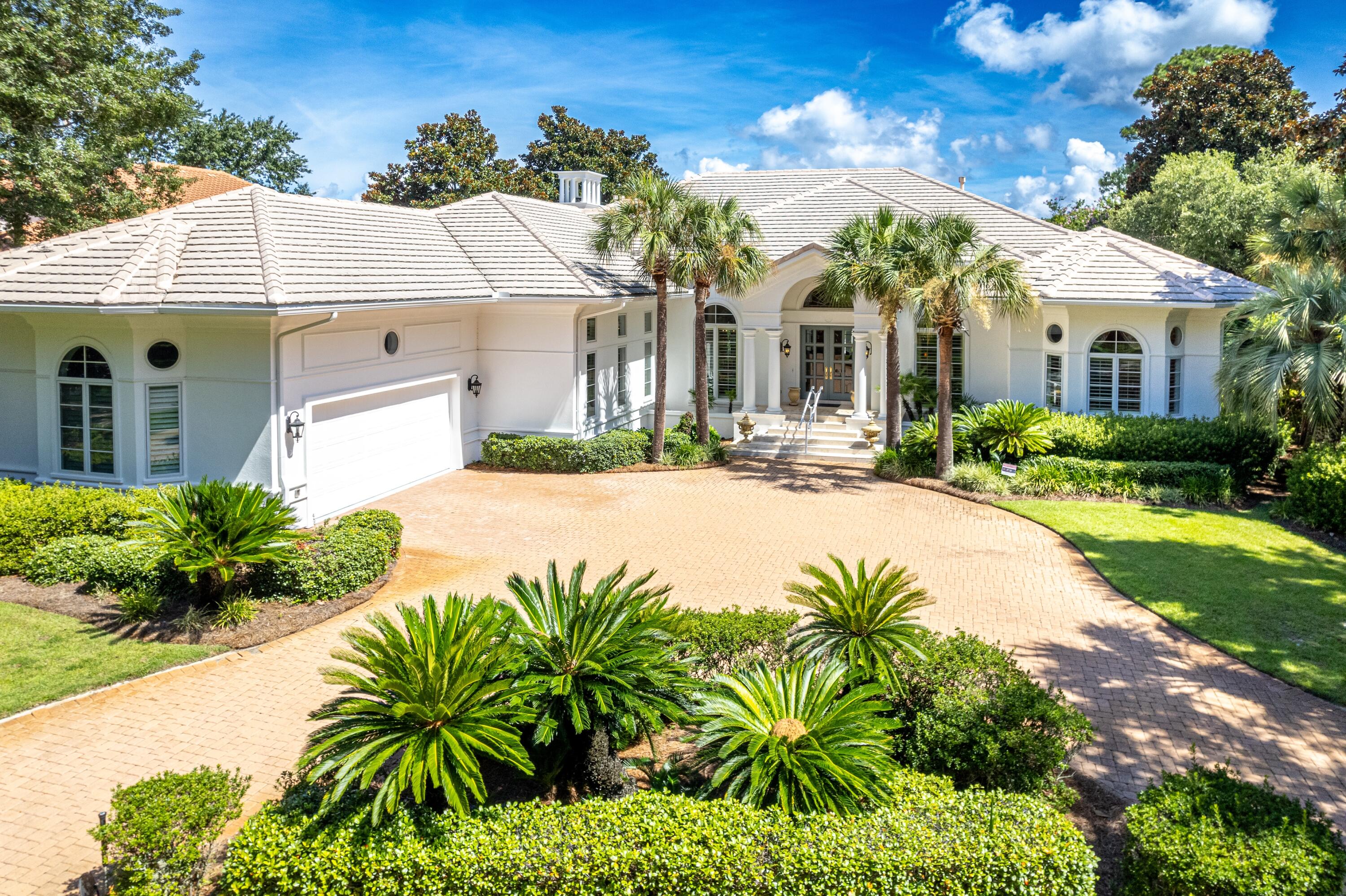 Refined Single-Level Living with Poolside Perfection and Golf Course Views in the heart of Burnt Pine at Sandestin. Experience this exquisite Palladian-inspired estate, ideally positioned along the 10th fairway of the renowned Burnt Pine Golf Course with sweeping lake views. Designed for both comfort and elegance, this single-story home showcases a stunning octagonal porch leading to a private pool and waterfall spa—your own backyard retreat. Inside, the thoughtfully designed layout features four spacious bedrooms each with en-suite baths, a powder room, dedicated office, two living areas, formal dining room, and a cozy breakfast nook. Soaring 18-ft ceilings, plantation shutters, Italian marble flooring, and Hickory hardwood in all bedrooms create a luxurious yet timeless aesthetic. The remodeled gourmet kitchen is a chef's dream with quartz countertops, a tiled backsplash, an entertainer's island with gas cooktop, a new Bosch dishwasher, and a Kitchenaid trash compactor. Additional upgrades include dual new gas water heaters (2022), new HVAC systems (2018 & 2020), a 2022 whole-home A/V system with surround sound and music, and fresh paint throughout the exterior and garage (2024).
As an introduction to the Sandestin lifestyle, we invite our new owners to explore amenities that make Sandestin special. The listing brokerage and seller(s) are presenting the buyer(s) of this property with (2) 90-minute rounds of Tennis court time, a golf foursome at one of our three championship courses, and a round of golf for up to four (4) players at the unrivaled Burnt Pine Golf Club.
Sandestin Golf and Beach Resort features more than seven miles of beaches and pristine bay front, four championship golf courses, 15 world-class tennis courts, a 226-slip marina, a fitness center, spa and celebrity chef dining. Shop, dine and play at the charming pedestrian village, The Village of Baytowne Wharf and more. Inside the gates of the resort, residents enjoy a balanced lifestyle of high-class living, spanning the 2,400 acres from the beach to the bay. Everything within the gates of the resort is accessible by golf cart or bicycle. The entire resort is interconnected by miles of pedestrian, bike and golf cart paths that weave through groves of live oaks, meandering past natural lagoons, fountains, man-made lakes, and meticulously landscaped fairways.