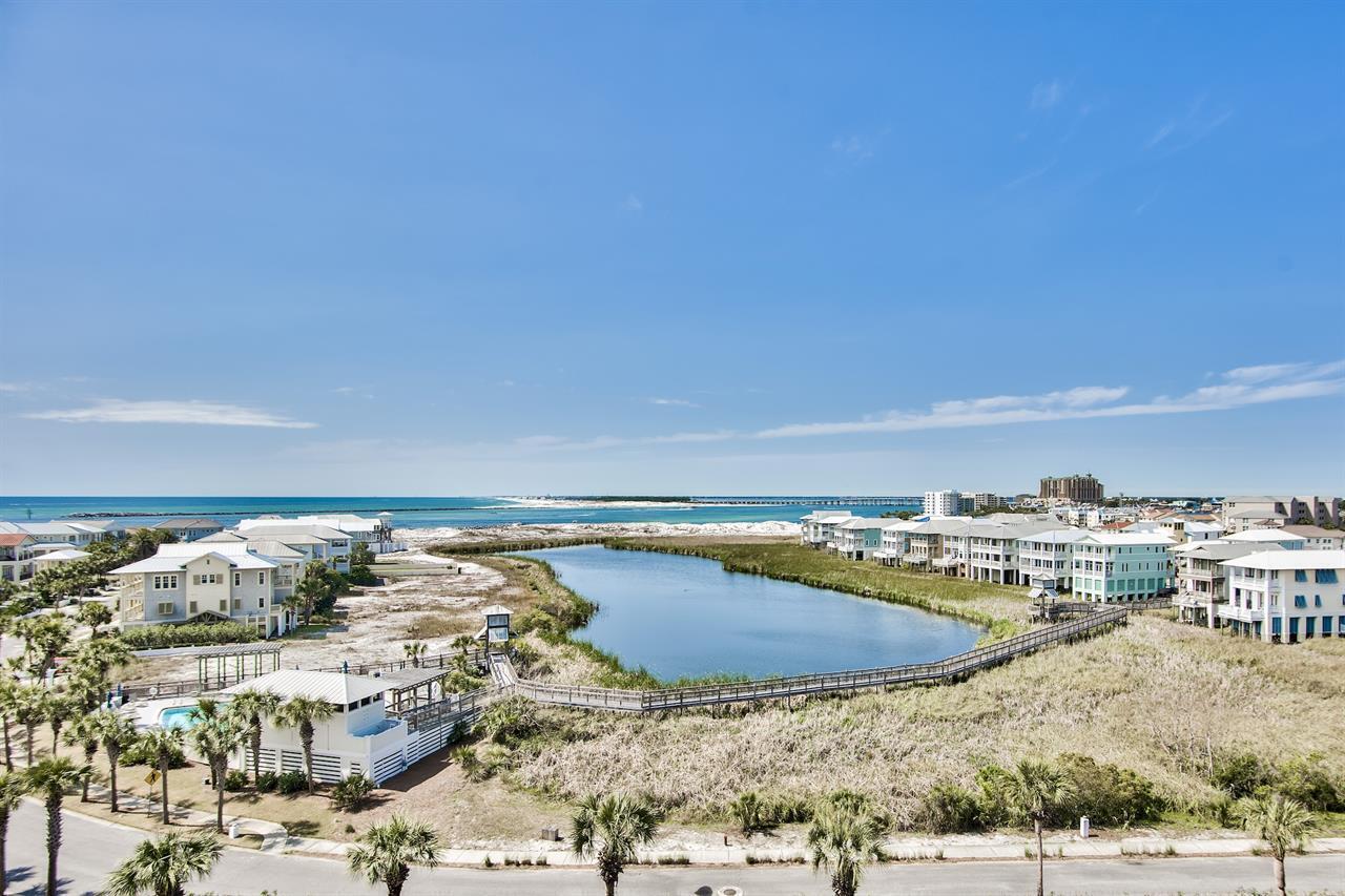 This top floor beauty is an Income-producing condo on the Jetty East rental program. 2023 gross income was $66,000, 2024 was $58,130. Please see rental history and reservations for 2025 in documents section. This lovely, updated 2 bedroom, 2 bathroom condo is being sold fully furnished. Gorgeous views of the East Pass and the Gulf! Spa-like bathrooms and granite throughout bathrooms and kitchen give an updated feel. Kitchen has stainless appliances, double sink, backsplash and custom cabinets. In unit laundry for convenience. Details such as built in USB receptacles offer convenience and ease when staying away from home. Tile floors throughout and no carpet. Hot water heater has been replaced as well. Jetty East Amenities include a 2400 sq. ft. pool with sun deck, hot tub, beach side pavilion with charcoal grills, tennis courts, pickleball, fitness room, kid's activities, music entertainment, shuffleboard, owners meeting room and of course 900 feet of Sugar White Sand! There is 24 hour security in place as well. Call today to schedule a tour.