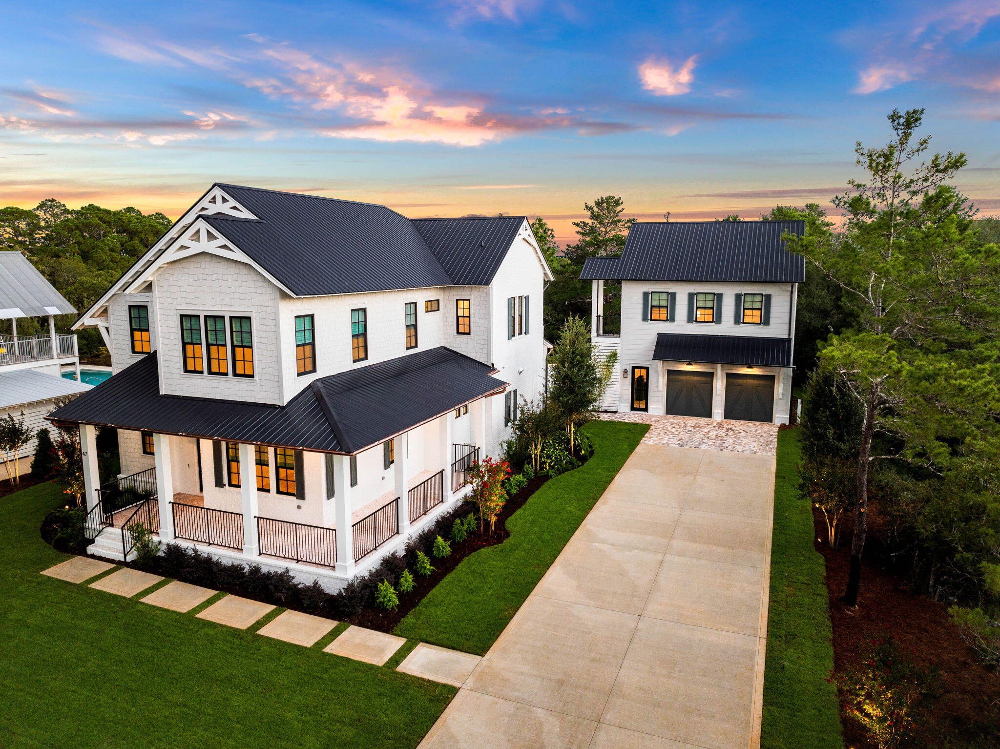 Step into coastal luxury at 47 Grande Ave, a newly constructed masterpiece by Cogent Building Group, perfectly situated on the west end of 30A. Boasting  4 bedrooms, a carriage house and impeccable design, this home offers an effortless blend of modern comfort and classic beach living.

The first floor greets you with an expansive living room that flows seamlessly into a gourmet kitchen, designed with both elegance and functionality. Perfect for entertaining, the space features custom cabinetry, high-end appliances, and a central island that invites casual conversation. The first floor also hosts a guest bedroom, providing privacy and convenience for visiting family and friends. Ascend to the second floor, where you'll find two guest bedrooms and the lavish primary suite. The primary retreat features a spa-like ensuite bathroom and an oversized walk-in closet equipped with built-in laundry and a steamera detail that elevates everyday living to extraordinary.

The exterior is designed for relaxation and entertainment, with a private pool and hot tub offering the perfect setting to unwind under the Florida sun. Beyond the main house, a fully equipped carriage house adds flexibility to this remarkable property, complete with an additional guest bedroom, kitchen, living area, and a garage belowideal for hosting guests or generating rental income.

This home invites you to experience the best of coastal living, with refined details and a setting that embraces both comfort and style.