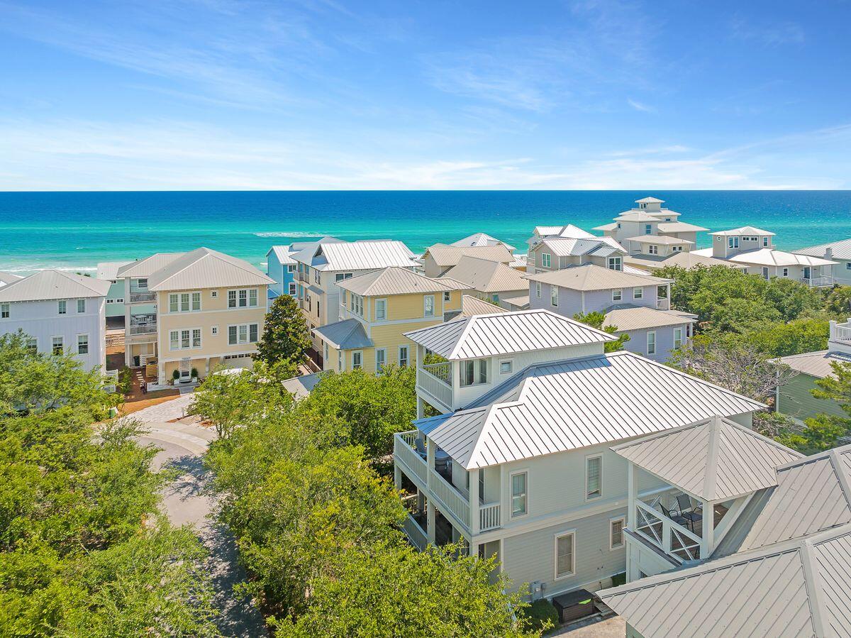 Steps from the beach boardwalk and community pools, this well-appointed beach house maximizes its location with stunning gulf views from the upper floors. This home includes tasteful furnishings which have been recently replaced and comes with deeded beach access. A generous driveway provides ample parking for visiting guests and friends. Recently updated, this beach retreat has many attractive features including terraces on all levels and updated kitchen and bathrooms. The third-floor tower room is a hideaway for youngsters who get their own bunk room with a seaside mural and a wet bar for soda and snacks while watching TV. Magnificent sunsets and gulf views can be enjoyed from the upper balcony. The second floor reveals an open family room with wood flooring, perfect for mealtimes, socializing and watching movies together. The updated open kitchen is at the heart of the action with quartz countertops, contemporary backsplash and stainless appliances making mealtimes and snacks quick and easy. Dine together at the dining table or out on the balcony with salty sea air and stunning gulf views sharpening the appetite. Rounding off this level there's a king-size owner's suite with office/ sitting area. The opulent en suite bathroom boasts a soaking tub, walk-in shower, double vanity and a glittering chandelier. The first floor has two further sumptuous guest bedrooms and a bunk room sharing an ensuite and a Jack-and-Jill bathroom. The stylish decor echoes the beachy laid-back vibe throughout the home. Look forward to morning strolls along the sand in search of seashells or a cooling dip in the nearby community pool after lunch. You can be wriggling your toes in the soft sand just 90 seconds from the door. Seaside, Florida, and Rosemary Beach are a short bike ride away for boutique shopping, alfresco dining and live entertainment. Ideal as a second home for gatherings or as a prime located vacation rental this is a home for spending quality time with loved ones, listening to the sounds of the sea and toasting sunsets. Home sold fully furnished and rental ready. Buyer to verify all information and dimensions.
