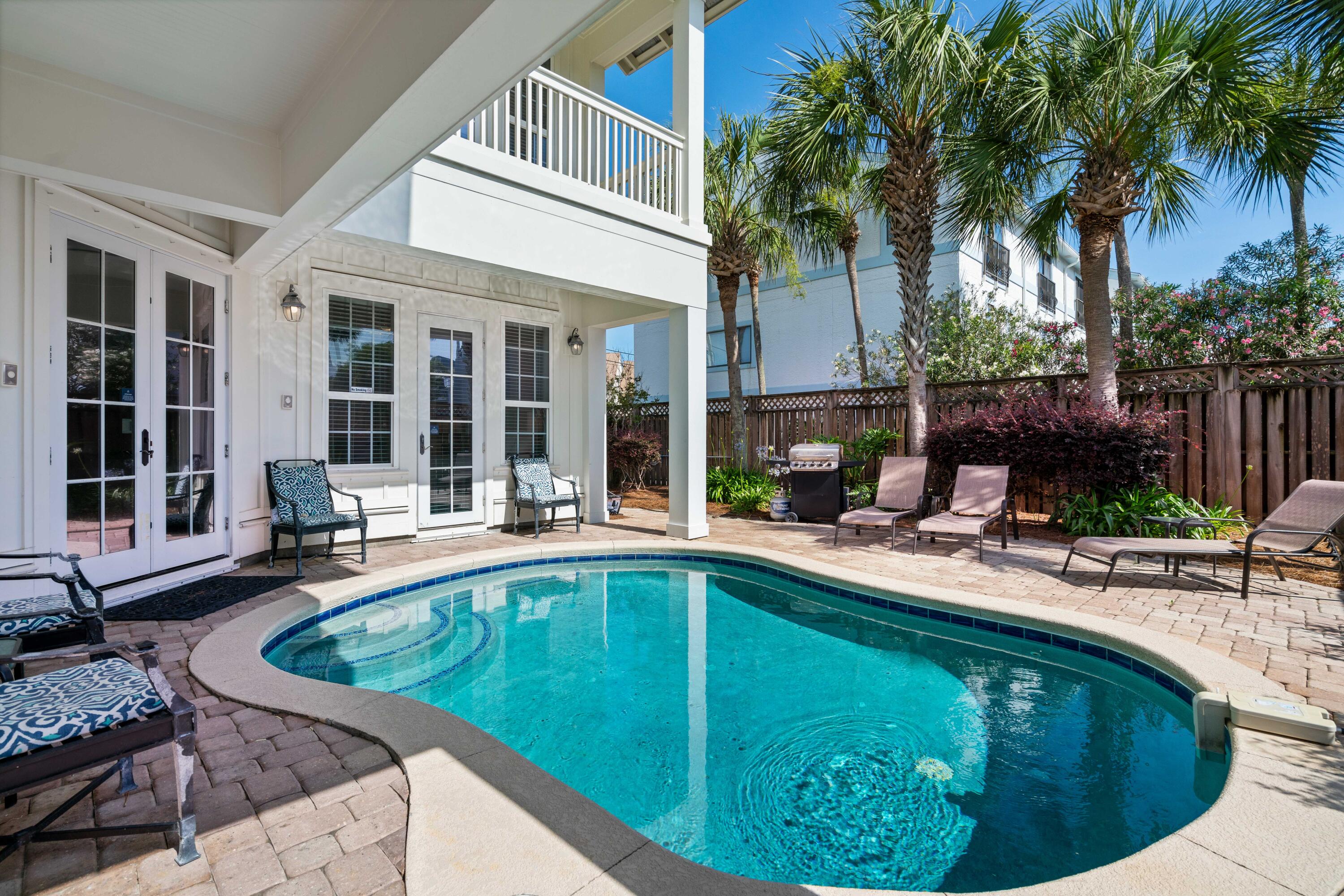 Exemplary coastal charm juxtaposed beautiful panoramic gulf views with prominent positioning in the heart of Miramar Beach characterize this masterful residence which offers over +3,800 sq ft of living space spanning an impressive four-story vertical footprint which allows for sweeping gulf vistas. This property conveys with a 70'x 60' additional vacant land footprint allowing exceptional room for growth including a potential gulf view carriage house, larger pool, etc. Exceptional investment opportunity abounds with $237,000+ in projected gross annual rental revenue. This five bedroom home epitomizes coastal living, prominently situated just a half block off the gulf with close proximity to Pompano Joes restaurant and beach access. Notable features include a private elevator, 10-11' ceilings with vaulted master bedroom, spacious pool area complete with privacy fencing, two-car garage, covered wrap-around porches with tongue & groove cypress accents, oak hardwood flooring on the second and third floor, durable porcelain tile adorns the first level and wet areas. The open floor-plan accentuates this property's generous proportions & thoughtful design; the first floor features a spacious game/living room all of which is open to the rear pool deck, perfect for entertaining and complete with bunk spaces as well as a full king bedroom suite. The second floor is the epitome of open living with generous proportions including an open kitchen featuring stainless appliances as well as custom cabinetry artfully decorated and professionally designed. The second level also features a suite & ensuite bathroom. The third level offers a large master suite complete with an ensuite bathroom that is outfitted with dual vanities, spacious walk-in shower and private water closet. The third floor also offers additional bedroom suites and a spiral staircase access to the roof-top deck oriented to offer uncompromising sunset views and views over the Gulf of Mexico. Miramar Beach offers world class shopping, restaurants and local entertainment as well as access to the beautiful white sand beaches and emerald green waters of the Gulf of Mexico.