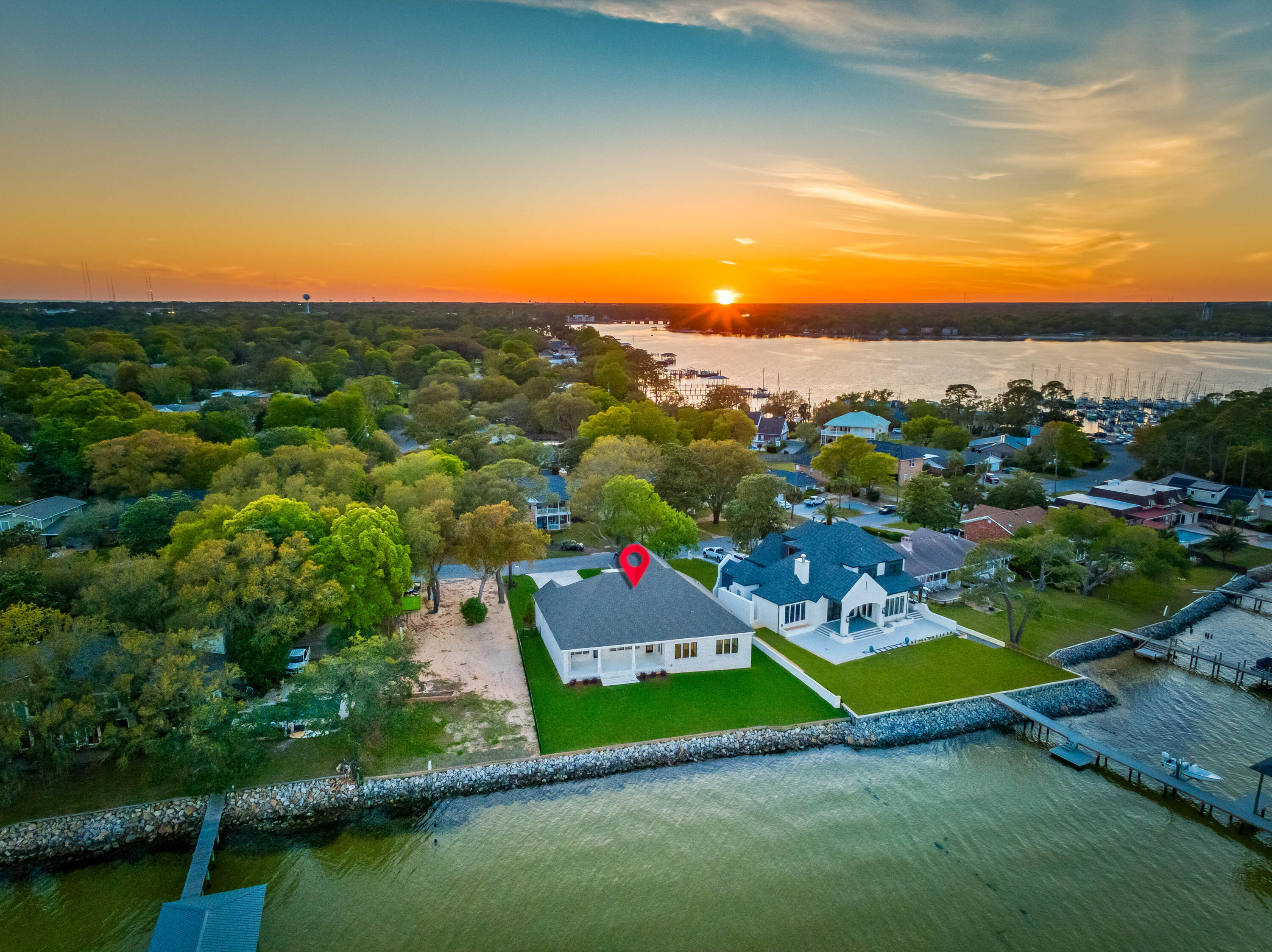 BRAND NEW LUXURY BAY FRONT PARADISE WITH 107 FEET ON THE CHOCTAWHATCEE BAY WITH SPACE FOR A POOL! This New 2024 Build boasts breathtaking views of the Bay & Destin's iconic Emerald Grand. It's prime location features the best Sunrises and Fort Walton Beach Yacht Club nearby.
The elegant entry foyer greets you as you enter and sets the tone for the entire residence. The 10' ceilings, LVP flooring, open floor plan all seamlessly combine the living, dining, and kitchen areas, all with PANORAMIC views of the Bay. The cozy outdoor fireplace, makes it easy to enjoy the waterfront scenery.
The Chefs kitchen is equipped with Thermador appliances, a full size fridge and freezer, a 48' gas range and an over sized island. A wet bar with an ice maker, beverage cooler add luxury and convenience. This home offers 4 bedrooms, each designed with comfort and privacy in mind. The primary suite is a true retreat, featuring Bayfront views, an expansive layout. Its large Ensuite bathroom has a separate shower, a relaxing garden tub, and a massive walk-in closet.
In addition to the 4 bedrooms, there is a dedicated office space, perfect for those who work from home or desire a quiet place for productivity.
Outside, the possibilities are endless. With ample space for a pool, you can create your own private oasis for lounging, swimming, and enjoying the coastal lifestyle. With space for a Dock and Boat Lift, the bay frontage allows for easy access to water activities.