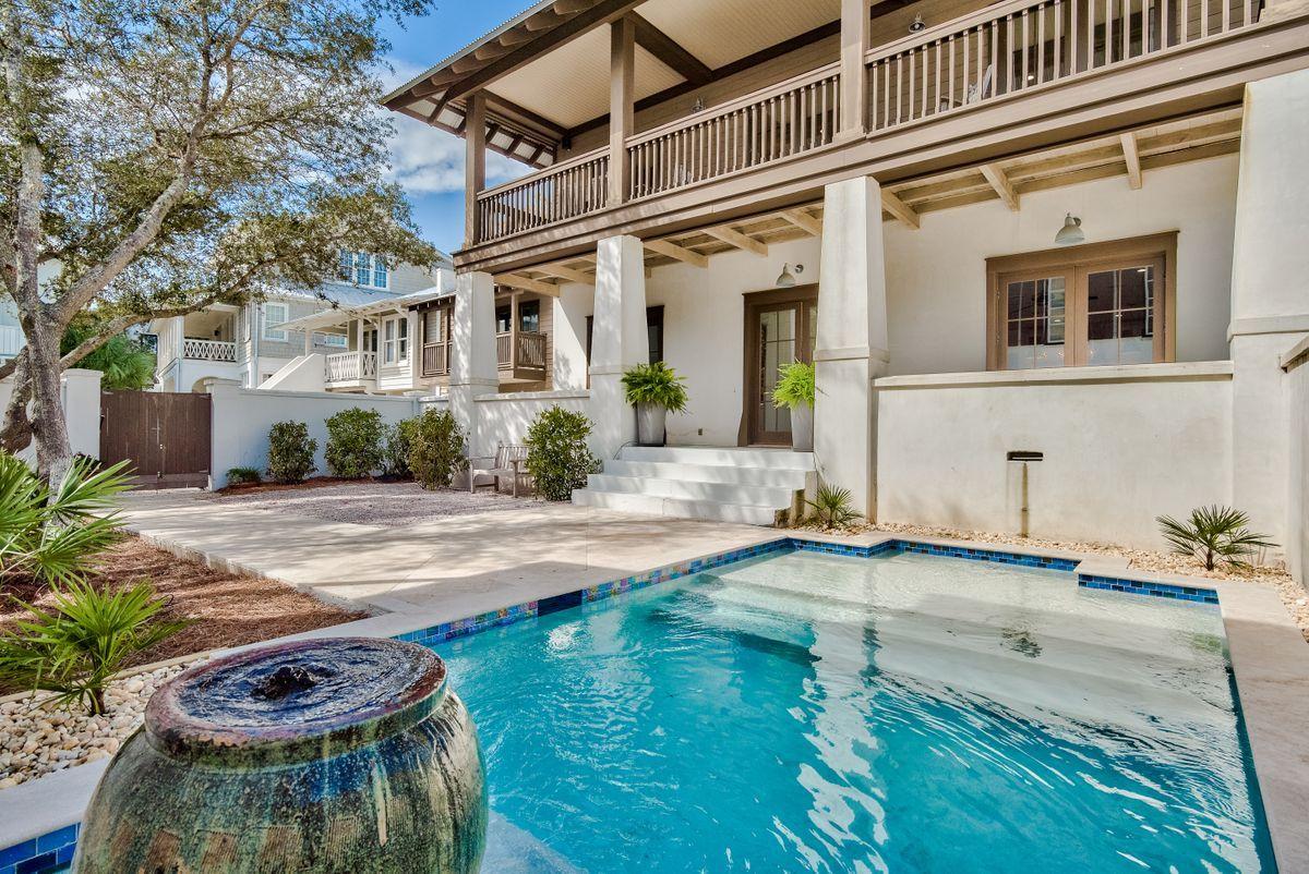 Nothing like a pool to complete the resort feel of this Rosemary Beach abode with exceptional outdoor living. Entrance to the home is through the courtyard in true New Orleans style. The expansive front porch hosts a bank of French doors that open into the double living areas, one serves as a media room and the other opens to the dining and updated kitchen. There is also a prep kitchen offering the extra space for entertaining at the beach. An elevator adjoins the stairs to access Level II where the master suite and two guest suites reside. A broad balcony across the front provides a lofty perch to enjoy the Gulf breezes. The carriage house over the garage provides a wonderful studio apartment for your guests with a full kitchen and bath. This South of 30A location enjoys a Beach access close by and a  short stroll to the Rosemary Beach Town Center of copious shops and restaurants.