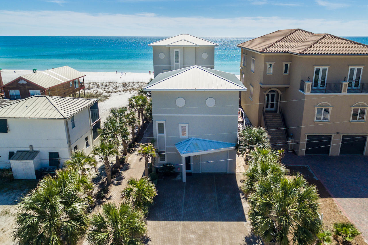 Old Florida living meets today's coastal design. Comprised of 2 homes, the fully renovated Gulf Splendor masters beachfront living. The gulf front, 4-story beach house provides endless gulf views and the 3-story guest house on the street side offers additional space along with corridor views of the gulf. Both homes include private swimming pools.
From the second-floor living space of the beach house your eyes are immediately drawn to the wall of large windows and the emerald green waters beyond. Open concept with a light and airy feeling, the living/kitchen/dining/wet bar is a natural gathering space. Open the French Doors and let in the warm salt air breeze or step out onto the deep balcony. The living room features a gas.. fireplace surrounded by built-in shelves. The newly updated kitchen features white cabinets, a quartz countertop and new stainless steel appliances. New hardwood flooring is strikingly present in both homes. The third floor has 2 gulf front bedrooms complete with private baths and a shared gulf front balcony. A bonus area on the third floor has been made into a bunk room, but can easily be converted to an office space. The entire fourth floor is a master retreat fit for a king, complete with a sitting area, wet bar with a wine fridge, walk-in closet, a private bath with dual vanities and an oversized walk in shower, and a private balcony.  All floors are easily accessed by the elevator. The first-floor area has an owner's closet and laundry room with access to the private pool and outdoor covered patio area. The patio area has a BBQ and a bar area complete with a fridge. 
Gulf Splendor's guest house has 4 bedrooms and 4.5 baths. The main floor has a bedroom with private bath. The second floor is an open concept living, dining and kitchen area, all newly renovated. The living room also has a wet bar area complete with a wine fridge and sink. Step out onto the balcony from the second floor to a private pool and gulf views. There is also a half bath and laundry room on the second floor. The third floor has 3 bedrooms. The front 2 bedrooms have gulf views and private baths with the third bedroom being a bunk room with private bath. 
Call today for a private showing.