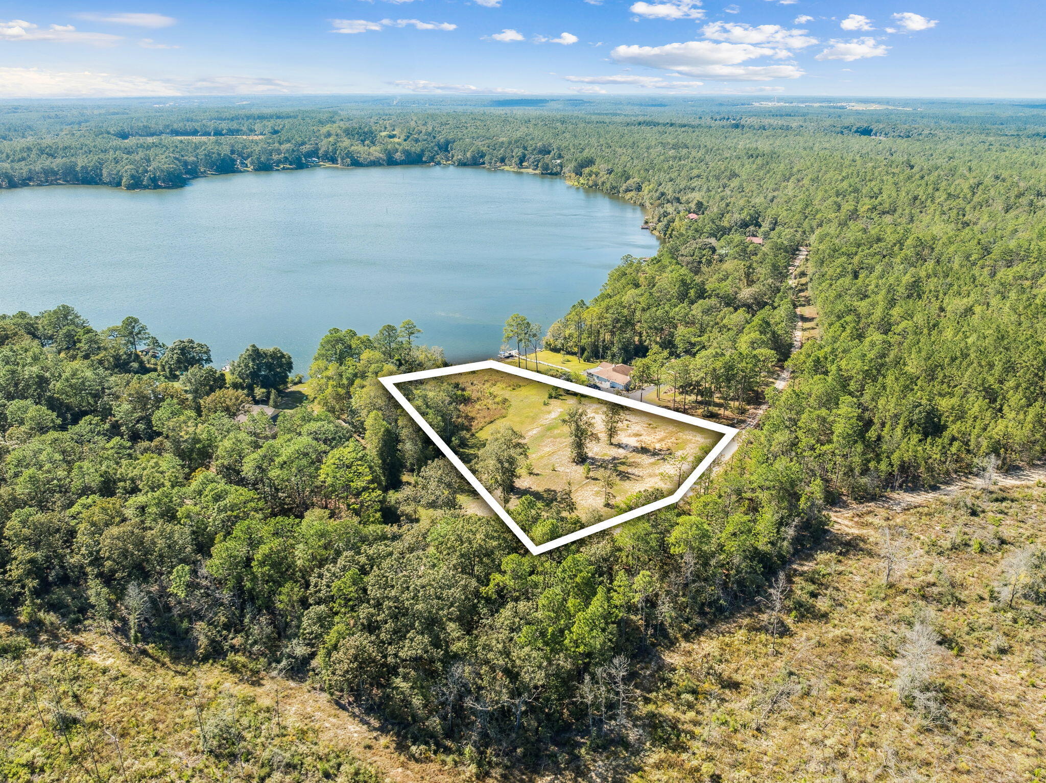 Discover the perfect blend of serenity, space, and waterfront living with Lot 29 Spring Lake Road, a stunning 2.35-acre parcel nestled along the pristine shores of Spring Lake in the heart of DeFuniak Springs. This unique piece of land offers a rare opportunity to build your dream home or vacation getaway in a peaceful, natural setting with direct water access and expansive views.

Surrounded by towering trees and native Florida foliage, this generously sized lot provides plenty of privacy while still offering an open, usable layout. With over 2 acres of land, you'll have room to create the lifestyle you've always wanted—whether that means building a custom lakefront home, adding a guest cottage or workshop, or simply enjoying the land as your own personal retreat. What truly sets this property apart is its direct frontage on Spring Lakea quiet, scenic, and lightly developed body of water perfect for kayaking, canoeing, paddleboarding, fishing, or simply relaxing by the shoreline. Imagine waking up to the sound of birdsong and watching the sun rise over the calm water from your back porch, or spending your evenings enjoying the peaceful reflections of the lake.

Access to the lot is via Spring Lake Road, a quiet, well-maintained street that offers both privacy and convenience. You'll feel a world away, yet you're still just a short drive from the charming historic downtown of DeFuniak Springs, with its classic Southern architecture, shops, cafes, and the famous Circle Drive surrounding Lake DeFuniak. You're also less than an hour from the white-sand beaches and emerald waters of the Gulf Coast.

Whether you're looking for a full-time residence, a seasonal escape, or an investment in Florida land, Lot 29 Spring Lake Rd offers the space, location, and natural beauty to make your vision a reality.