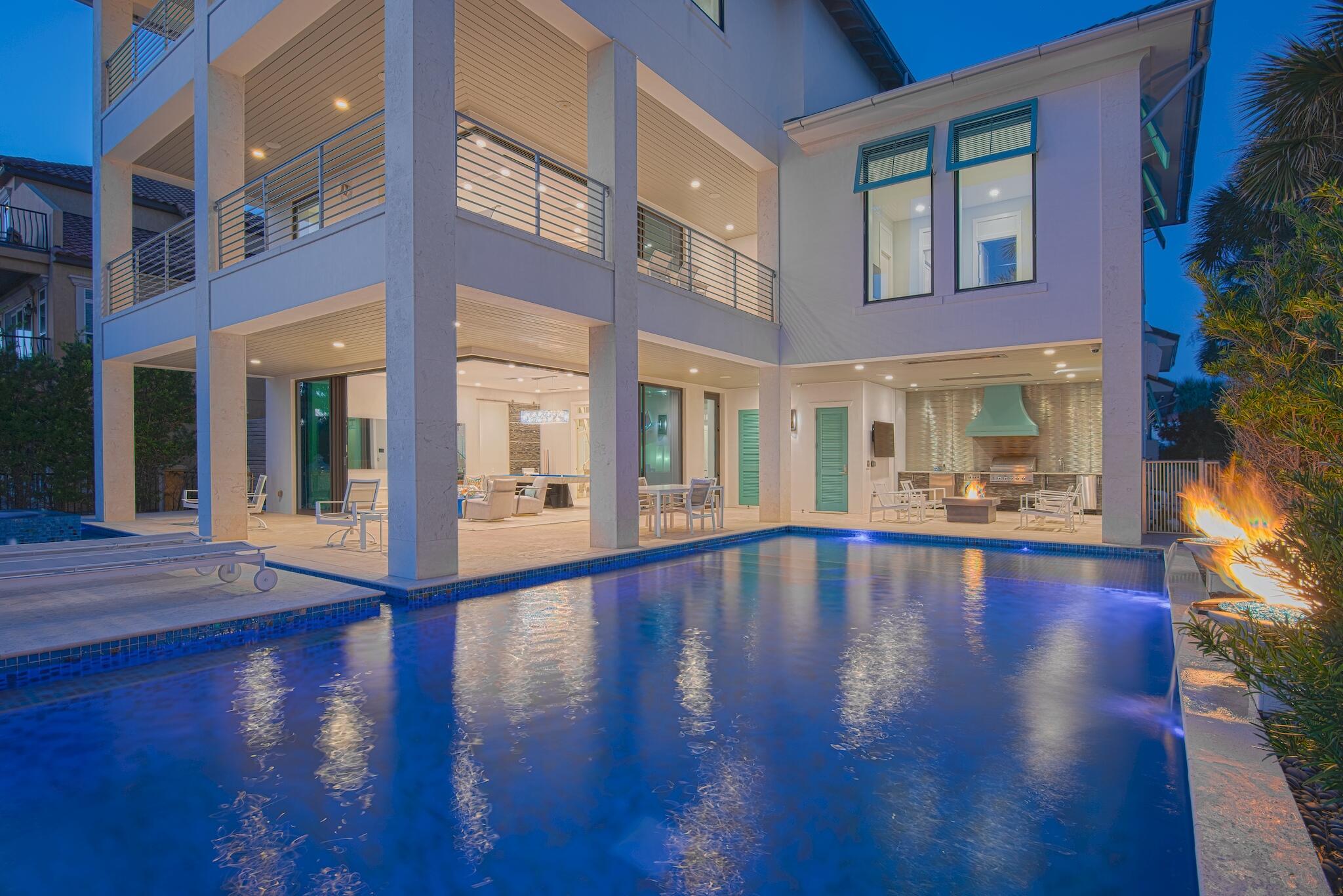This impeccable home is the epitome of coastal modern design. It was carefully engineered and designed with a relentless attention to detail. No expense was spared in its creation, from the building materials that were chosen, to the finishes and selections that were made to create its sleek modern décor. This property is the embodiment of elegance and design. The Custom built, all-concrete structure is just shy of 6,000 sqft of conditioned living space and over 8,800 sq ft of living space under roof. The five bedroom, five and a half bath home is just steps to the beach and offers uninterrupted views the Gulf of Mexico. It boasts one of the most unique and impressive pools along the coast and affords the very essence of outdoor living. Glass doors on the first and second levels wrap...... around the entire south elevation of the home and stack back to bring the outdoors in and frame the vistas of the pool deck and Gulf. The first-floor features two of the four private guest suites and is home to the lower-level game room. The game room features a custom-built Mitchell pool table, 80" mirror TV, fire feature and opens onto the expansive pool deck. The pool's hallmarks are the custom hand-laid tiles, water urns, fire features, island sundeck and spa.  The outdoor entertaining area includes an outdoor kitchen with grill, beverage center, icemaker, and custom designed Kamado charcoal grill. Upon entering the residence your eyes are immediately drawn to the handmade stairwell that was fabricated in Italy; a perfect example of blending design and function. It's quite simply a work of art. As you ascend the stairwell to the second level you cannot help but to focus on the hand-blown Italian Chandelier that extends from the first floor to the second level. Upon arriving on the second level, your eyes are immediately drawn to the gourmet kitchen that's certain to please any epicurean. The kitchen is well appointed with Wolf and Sub Zero appliances including built-in steamer and warming drawer and is open to the dining and living area; making it ideal for entertaining. The living area spills out onto the expansive balcony and takes full advantage of the coastal views. There is a sleek fireplace adorned with Swarovski Crystals to keep you warm as you take in the water views on a cool evening. Also, on the second floor is the third guest suite, which too, takes full benefit of the water views. On the Third floor, one will find the owner's retreat. It's the premier vantage point in the home for enjoying the vistas of the gulf and is your own private sanctuary. The glass doors stack back to allow the outside in and create and ease of flow from one space to the other for its owner. The ensuite includes a walkthrough shower spa, solid granite tub and hidden walk-in closet with mechanized rods and shelving for ease of access. The concrete structure is engineered with three HVAC units, two Ranai tankless water heaters, whole house water filtration system, whole central vacuum and whole house 85 KW Generac generator. Nearly a quarter of a million dollars were invested into the custom Control4, Sonos and Lutron Smart Home, Audio & Lighting Systems. Each floor has its own iPad that allows one to control the lighting, comfort and audio throughout the home. Additionally, all of the homes smart features can be controlled wirelessly from your phone while at home or away. For those discerning investors that seek the essence of design and coastal living, you've found your retreat. 

The property is under contract subject to a 72 hour kickout clause. 

A complete list of the construction features can be found under the documents tab for your review. And while this home has never been rented, it has projected gross revenue of over $400k annually, which is available upon request.