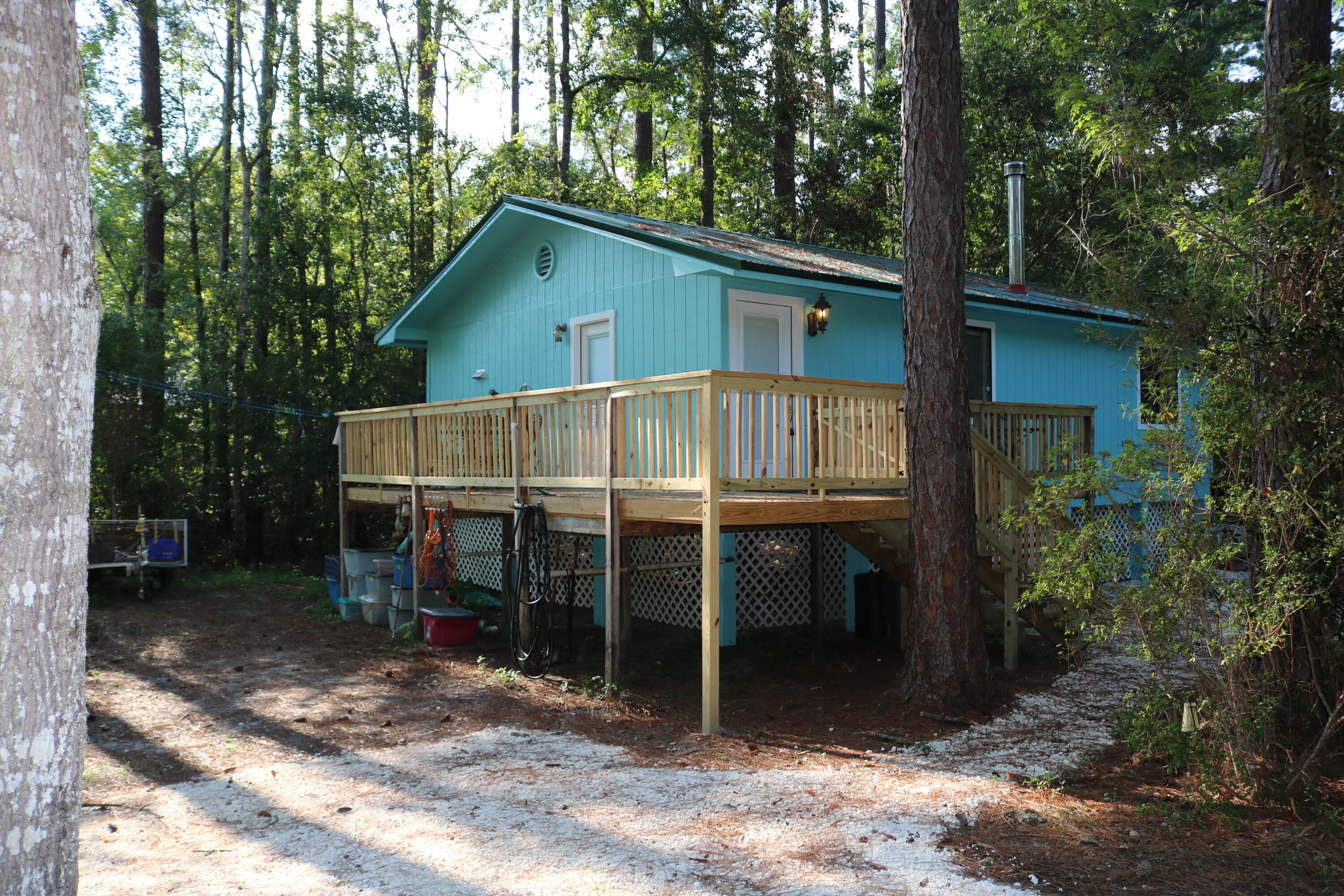 Come take a look at the move in ready home.  This home is located just minutes away from the Choctawhachee River and Boat Launch. This home has been recently updated with a new paint inside and out, new wood for the deck/porch, Gravel for 2 parking areas, Insulation in the attic and the roof is only 4 years old. Owner just installed a private well for this home also in July 2024! This is a very quiet location and only minutes from Panama City or Freeport. The lot is big with plenty of room for growth or room for your water toys! Come take a look at this beauty!