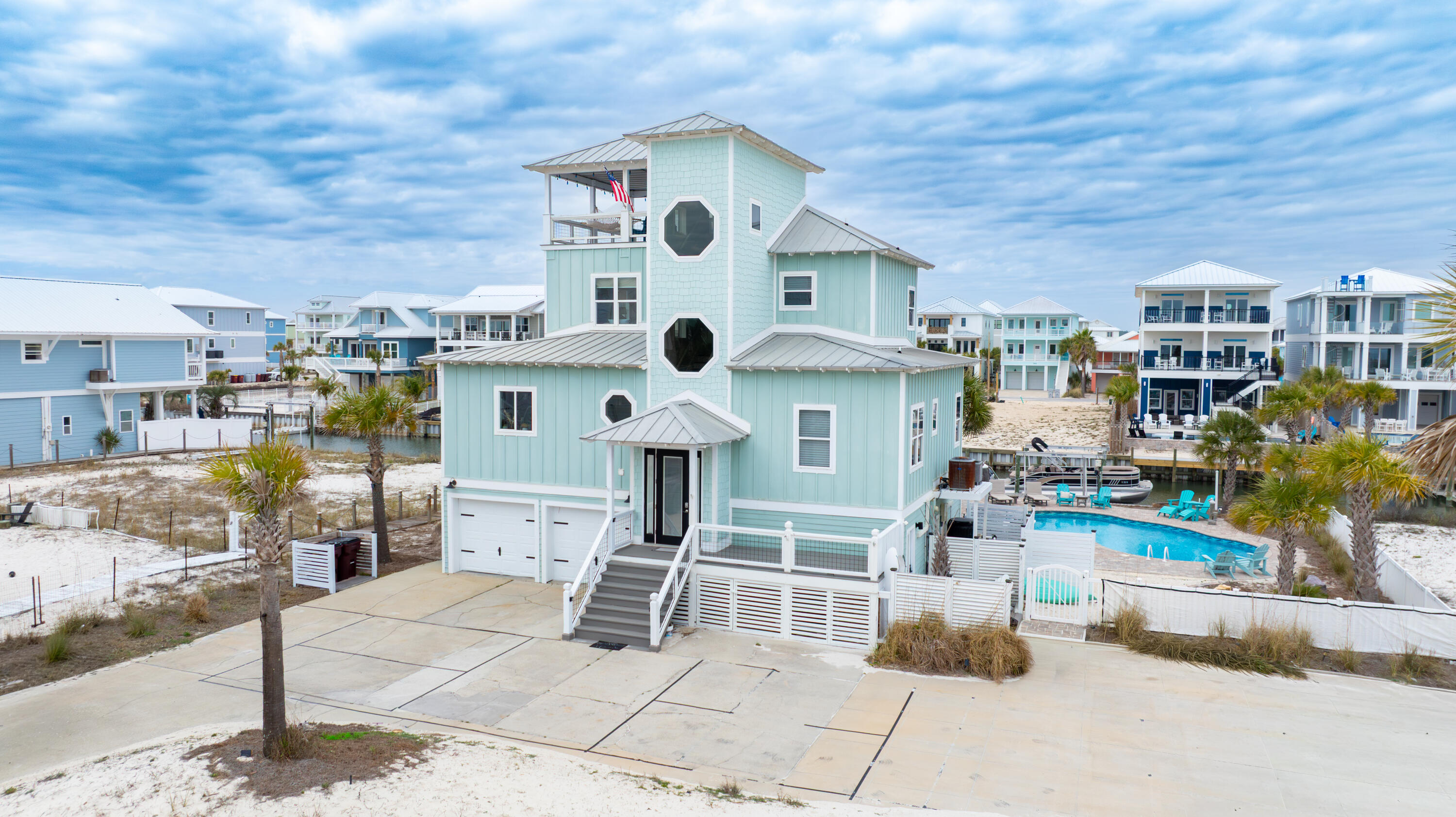 Canal-front living on Navarre Beach! This beautifully updated 4-bedroom, 3.5-bath home offers the perfect primary residence or rental income producing (projections $151K +/-). Enjoy your private heated and cooled saltwater pool, along with a dock and boat lift, making it easy to spend your days on the water. Designed for relaxed coastal living, the home features fresh interior and exterior paint, a remodeled kitchen, and new flooring throughout. A separate living qtrs. offers an efficiency kitchen, provides great space for family or use as a separate Airbnb. 
Outdoor spaces truly shine here. A large rooftop covered deck offers stunning views of both the Gulf and the Sound, creating the perfect setting for sunsets, entertaining, or simply relaxing in the coastal breeze. Ideally located just steps from the Gulf and beach access, this property offers the best of Navarre Beach living--boating, swimming, and beach days all within easy reach. A rare opportunity to own a canal-front home with incredible views, updated features, and exceptional outdoor amenities.