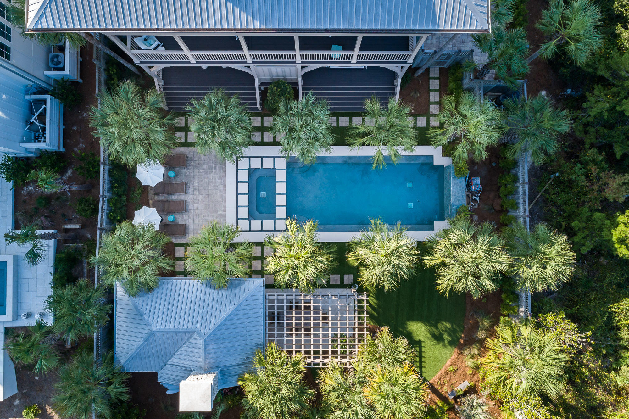 30 Gulf Dune is one of the most stunning and detailed estates to grace the Emerald Coast. With 5,249 sq/ft 4 bedrooms and 5.5 baths this home leave nothing to the imagination from the custom designed unique old world coastal wine cellar to the one-of-a-kind stunning outdoor pool unlike any. As you are greeted at the entrance with a large foyer and a floor to ceiling oyster/tabby accented wall to feature your most coveted art piece. The foyer is also accented with two custom built sliding barn doors that lead you into a custom designed office of your dreams. The main level has three master guest suites with private ensuites and large walk-in closets. Two of the suites face the back of the home with French doors that lead out onto a large balcony that spans the entire length of the home. The third suite is located on the front of the home with a kitchenette, double vanity private ensuite, and French doors that open onto a separate private balcony with views of the emerald green waters. As you enter the custom elevator, up to the third floor you are greeted with a small foyer and entrance into the open kitchen living and dining room accented with stunning beams, wood work, and lots of natural light. The kitchen has light granite counter tops, thoughtfully design custom cabinetry with custom spice racks, kitchen utensil racks, and even hide aways for your additional appliances. Located off the kitchen on the back porch is a custom grill area with built-in grill and green egg for easy access. The dining room, and main living room, offer spectacular open seating for those who love to entertain. The home is equipped and fully automated by the Control-4 system that operates the entire home electronically. The enormous master suite is located on this floor as well and spans the entire depth of the home from front to back. The master bedroom fronts the home with two sets of French doors that open on to a stunning porch that spans that length of the home as well. The master bath suite has double vanity, sperate make-up vanity, separate tub, large walk-in shower, and custom enormous walk-in closet with private washer and dryer. Upstairs from the third floor is an additional living/media room with wet bar, and sensational top balcony with 360degree views of the Gulf. The top floor also offers lots of heated and cooled storage and an additional office with storage. As you return to the 3rd floor you can take the stairs or hop back into your custom elevator down to the first floor that has amenities that are beyond your most luxurious imaginations. The first floor has a 3rd living, and tasting are to complement this truly indescribable old-world wine cellar with the perfect coastal flare. This is truly for the wine lover at heart. With a temperature-controlled room that holds over 600 bottles and a tasting area for you and your friends to enjoy your incredible collection of wines from around the world. As if all these amenities are not enough, the true gem of this home is outside. Nestled behind this stunning estate is the outdoor living of your dreams. An entire astro turfed yard with perfectly placed large pavers that lead you to the most uniquely design pool with water features and outdoor cabana with living area, a true fire place, outdoor dining, and outdoor custom designed kitchen. This estate also includes a massive four car garage with built-ins, additional heated and cooled storage, and direct access to the elevator. You will not want to miss the opportunity to own such a unique, and rare estate along the 30A scenic corridor.