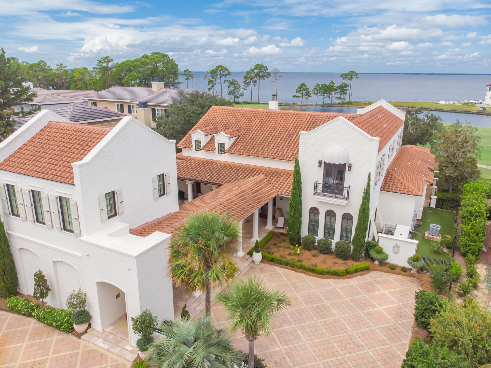 Designed by Tom Christ, this exquisite luxury home overlooking the bay and the golf course in the exclusive neighborhood of Burnt Pine holds your attention.  Elegant Ocean Reef coral stone floors throughout the first floor paired with creamy white walls grace the home for a soothing effect.   The hardwood floors on the 2nd floor carry a warm authenticity to the bedrooms.  Cozy sitting areas and different enclaves supply ample entertaining options for friends and family.  The ambiance of the open stone fireplace shared by the kitchen dining area and the living room entice you to slow down and savor a fabulous home cooked meal and a glass of wine from the house wine cellar.  The most fabulous kitchen for the sophisticated chef with gleaming white cabinetry and premier appliances  plus an enclosed separate grilling area and pizza cookery.  The beautiful pool lanai and the panoramic backdrop of the golf course stretching into the bay beckons everyone to enjoy the gorgeous outdoors.  Covered porches stretch languidly along the house. 
 Endless long windows from every room draw the incredible view inside.  This premier home, once featured in Veranda Magazine, lends to the imagination creativity with the highest regard for design.  

Burnt Pine is a gated community in Sandestin Golf and Beach Resort.  Sandestin offers a marina, beach access, 24 hour free tram service, tennis courts, swimming pools, concert areas, world famous restaurants and shopping, renowned golf courses, and miles of bike/walking trails.  For more information on the amenities in Sandestin, please visit: 
 https://www.sandestin.com/