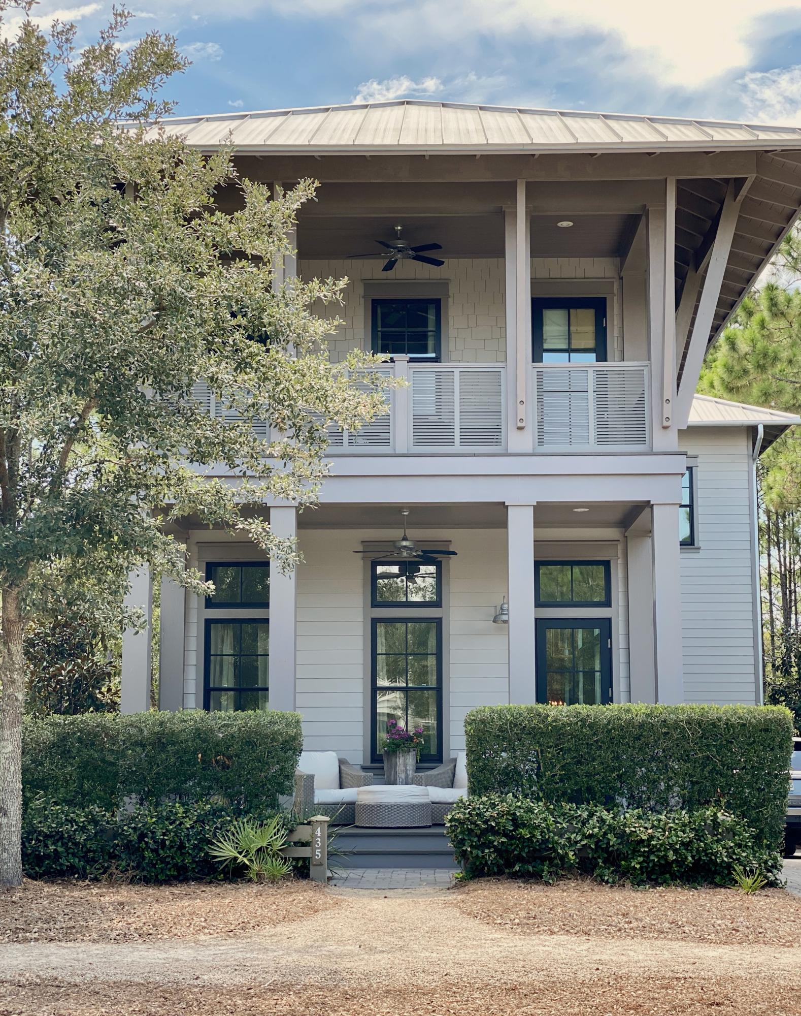 Beautiful home that is professionally decorated 4 bedroom and 4.1 baths that are all finished in marble. It features soaring 12' ceilings, distressed oak floors, abundant shiplap and lots of windows with great light. The gourmet kitchen features Thermador appliances and a large Carrera marble island perfect for entertaining.  The kitchen opens to the dining and living areas that flows onto a deep covered porch that overlooks the wooded conservation area in the rear with steps down to a paver patio with summer kitchen. The home also features a private additional living area that can be used as an office or den.  One of four ensuite bedrooms is conveniently located on the 1st floor. Two window-lined luxurious Masters have beautiful baths with private covered porches that have wonderful views This home is in a wonderful location, conveniently located near the new Camp Watercolor pool with lazy river and giant slide. Beautiful pool plans designed by Alan Holt with additional outdoor living area are included in the document section.
