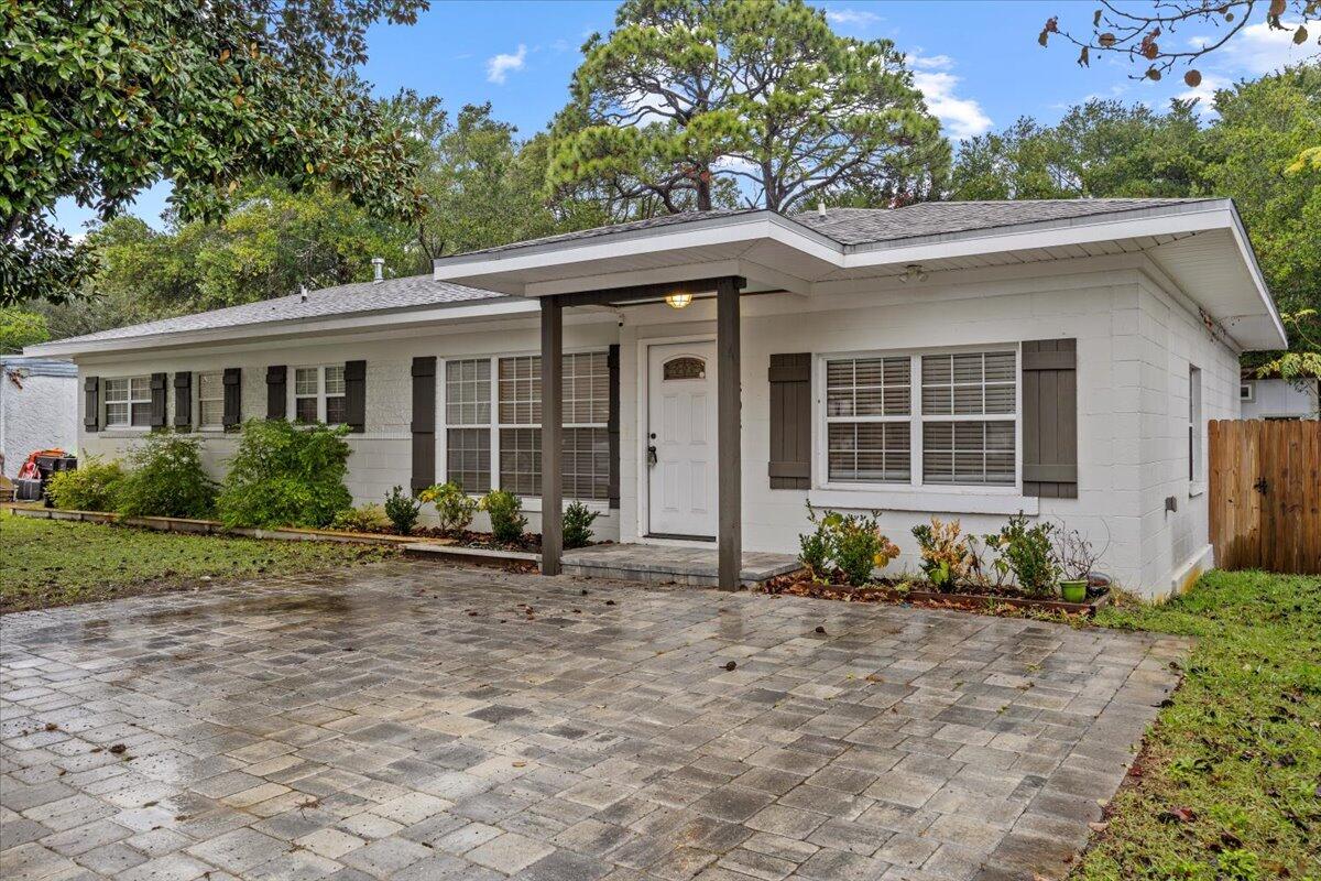 Welcome to this beautifully remodeled 3 bedroom 3 full bath home in sought-after Elliot Point neighborhood updated in 2021. Designed for comfort and easy living, this home offers two spacious owner's suites that offer excellent flexibility for your lifestyle needs. Step inside to discover modern vinyl plank flooring throughout, a welcoming dining area, and a living room with elegant trey ceilings & recessed lighting that creates a bright, inviting, atmosphere. The kitchen is a true highlight, showcasing crisp white cabinets, classic subway tile backsplash, and a gorgeous quartz countertops. The center island with breakfast bar provides the perfect spot for casual meals, entertaining guest, or simply gathering with family. For your peace of mind, this home comes with updated electrical and plumbing systems. Major components have been recently upgraded too, including new HVAC system (2023) and water heater (2023). Outside relax on spacious deck-perfect for enjoying those beautiful Florida evenings. The backyard also includes large storage shed, giving you plenty of room for tools, hobbies, or seasonal items. This move- in ready gem is conveniently located near schools, shopping centers, and local amenities. Don't let this opportunity pass by you!