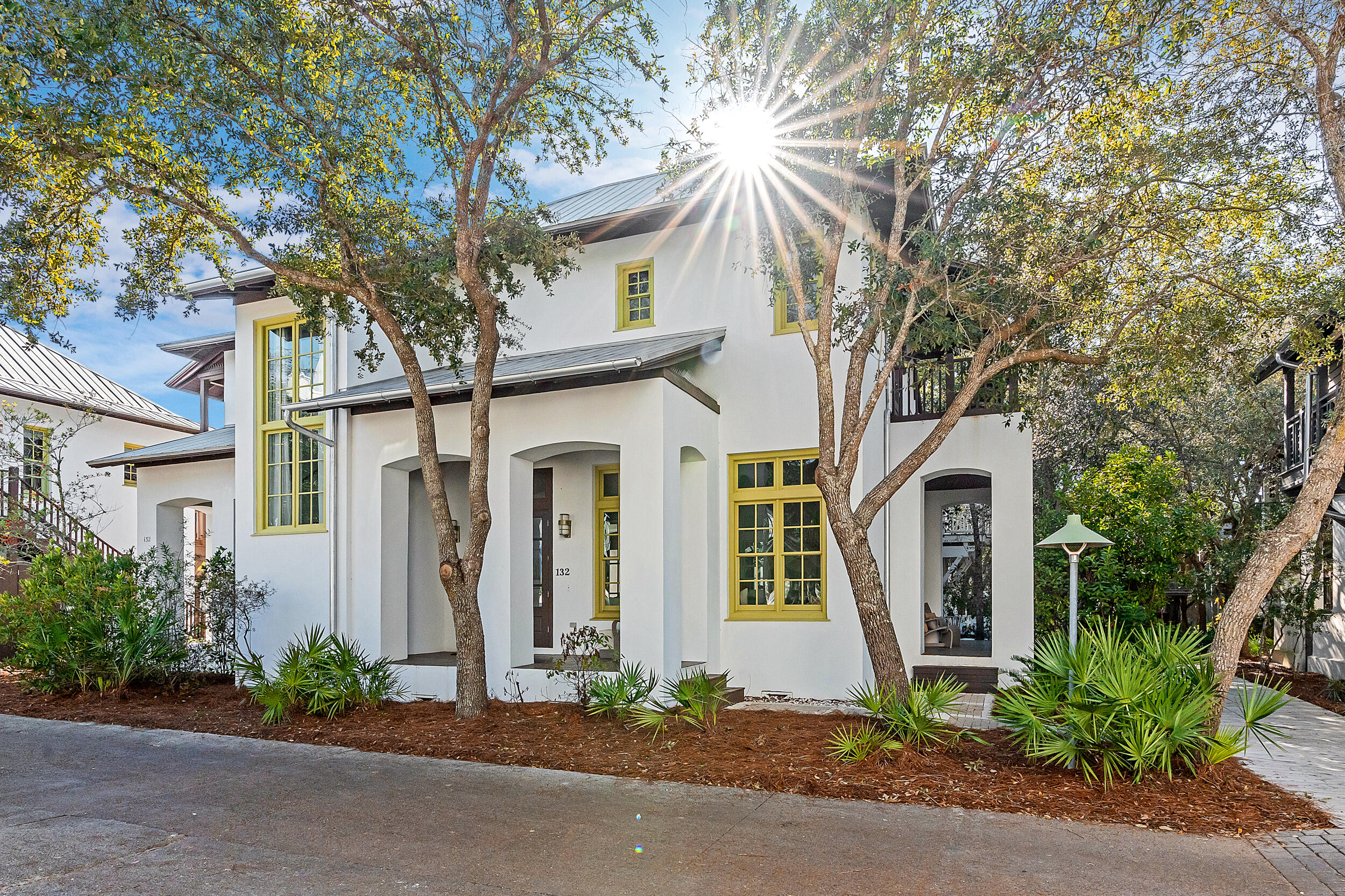Set on a coveted oversized corner lot in the heart of Rosemary Beach, 132 E Kingston Road is a five-bedroom, five-and-a-half-bath estate with a private carriage house and accommodations for up to fourteen. Rarely found in this community, the expanded homesite provides enhanced privacy and generous outdoor living—centered around a private heated pool, four-sided fireplace, dining loggia, and multiple screened porches and balconies.

The main residence showcases a fully renovated kitchen, dining, and living space with hardwood floors, designer finishes, and abundant natural light. En suite bedrooms each enjoy access to a private porch or balcony, including a newly updated primary suite with spa-inspired bath, soaking tub, and walk-in shower. The carriage house includes its own kitchen, living area, king suite, and balcony overlooking the pool.

Beyond the property, Rosemary Beach offers deeded beach access, four community poolsincluding an exclusive owners-only retreatand world-class amenities. Residents and guests enjoy biking to 30Avenue, Alys Beach, and Rosemary's boutiques, cafés, and award-winning dining.

132 E Kingston Road combines architectural elegance with the rare advantage of added privacy and outdoor space in one of 30A's most coveted communities.