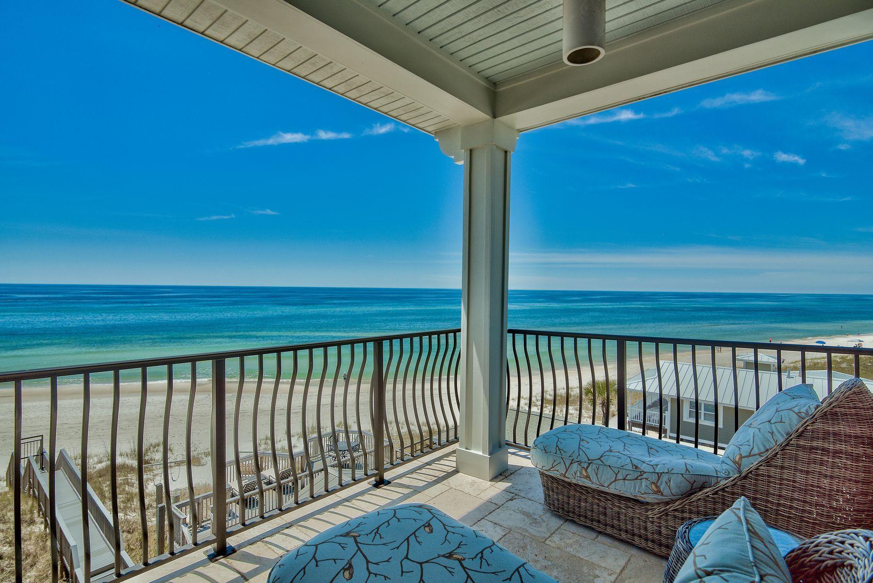 This stunning, multi-level, custom-designed home flanked by palm trees sits on the Gulf of Mexico and offers extraordinary, unobstructed views. A private beach walkover takes you to the water's edge and miles of beautiful, sugar white sandy beach. The exterior has recently been painted, and rustic interior oak floors have been reclaimed from a 100-year-old farm. Coupled with a pecky cypress inlay ceiling, these wood elements add the perfect natural flair to soft aquamarine walls with white trim. Architecturally significant features include crown molding, horizontal shiplap accent walls and ceiling, built-in shelves, an elevator and charming wine bar with wine cooler at the edge of the kitchen. Lovely white cottage cabinetry extends in front of the refrigerator, and a professional gas range contributes to the cooking experience. 

Wherever you are in the house, your eye is drawn constantly through huge windows to spectacular water views to the horizon. The master suite is a sanctuary of luxury with built-ins, recessed plank ceiling with dual fans, wainscoting and French doors that open to its own covered patio facing the gulf. The en suite bath sports glass, tile and a charming chandelier over the corner soaking tub. Guest rooms also have extravagant water views, and a bunk room is ideal for the teens, 'tweens and kids. The state park to the west assures conservation, and the levels and guest rooms assure privacy, comfort and beach views for everyone.