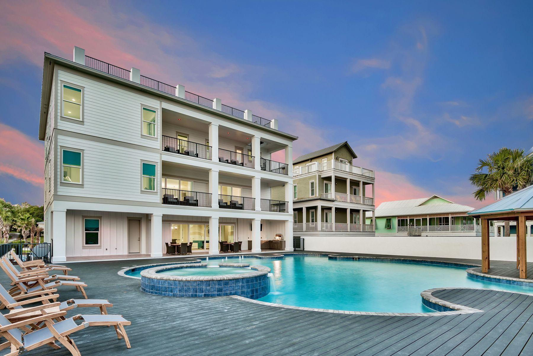 Newly completed and primely positioned directly on 30A this sleek coastal contemporary masterpiece offers panoramic gulf views from each of the three finished levels as well as the massive fourth story rooftop deck. This is the ultimate beach home; masterfully configured to provide unparalleled amenities including one of the largest private pools on 30A and optimized for entertaining with multiple indoor and outdoor living areas throughout the open floor plan highlighted by finely appointed furnishings & finishes professionally curated by Duce & Co. This property was strategically elevated to maximize the extensive gulf views from the massive pool deck which is anchored by a 50,000 gallon watermark-built private resort style pool complete with a swim up bar as well as an adjoining spa and covered gazebo. This property is an investment magnate offering $340,000+ gross projected annual rental income. Seller is offering a $340,000 gross annual rental guarantee for the first year post closing, through FiveStar Beach Properties. 

Notable features include multiple indoor and outdoor living areas, private elevator, dual master suites with gulf views and adjoining spa like bathrooms with floor to ceiling stone tile, built-in pinterest style bunkbeds, ample parking with two separate garage bays (one or both of which could be locked off and utilized for exclusive owner usage) and easy beach access located directly adjacent to the property. The first floor layout boasts two bedrooms with adjoining baths, as well as a spacious living room complete with gaming area and built-in wet bar offering easy access from the pool deck. The second floor is the focal point of indoor living space with a spacious living room characterized by floor to ceiling windows to soak in the beautiful gulf views and open to the oversized kitchen & dining area featuring custom cabinetry, stainless appliances, quartz countertops and ample seating. The lux kitchen also offers a sleek center island complete with built-in dining and accentuating the contemporary interior design of the home. The second floor also features a two full bedrooms with ensuite bathroom & half bath as well as access to the second story outdoor living area overlooking the lagoon style pool. The third floor features 4 full bedrooms including dual master suites, laundry area as well as built in bunks for additional sleep ability. There is a large den offering a supplemental living area as well as direct access to the oversized fourth story deck which allows unparalleled panoramic gulf & lake views as well as endless sunsets with a wide open western vista. This property is perfectly located in the heart of Dune Allen beach within excellent proximity to all of the boutique shopping, world class dining, array of outdoor recreational activities and local entertainment that 30A has to offer.