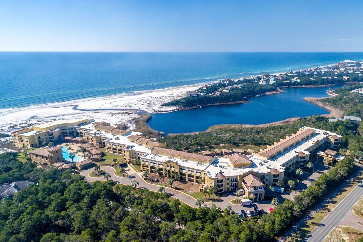 You have found a hidden gem on Hwy 30A - a stunning four bedroom, 4 1/2-bathroom, two-story condominium with 3,163 sqft. in Sanctuary By The Sea. This unique 23-acre property offers a serene retreat nestled between Grayton Beach State Park and Blue Mountain Beach on a wide and uncrowded beach. The Mediterranean style gated community with only 82 residences has four stories and rich amenities, including a boardwalk that leads to the 650-ft owned beach on the Gulf of Mexico and complimentary beach chair setups. A dock on the rare natural coastal Big Redfish Lake is perfect for fishing or launching kayaks, paddle boards. The property features three resort-style swimming pools with fountains, waterfalls, state of the art fitness center, movie theater, fully furnished Owner's Lounge with gourmet kitchen, outdoor whirlpool spas, 2 outdoor gas fire pits, and poolside grills, covered parking garage, seven temperature-controlled elevators, bike racks, and 24/7 on-site security with surveillance cameras. You can live in a refuge from the hustle and bustle while enjoying all the activities that this quaint Beach Town has to offer, such as world-class restaurants, shops, bars with live music, and art galleries, some of which are within walking or biking distance. This condo is perfect as a primary residence, second home or as a vacation rental with its 4 bedrooms and en-suite bathrooms. Enjoy expansive views of the Gulf of Mexico and Big Redfish Lake from the two Primary bedrooms, living room, and two levels of broad terrace space, it can't get better than this. The gourmet kitchen features Viking professional gas range in oven, vented hood, stainless steel fridge and pantry, separate wet bar with icemaker and wine fridge, perfect for entertaining. The gray contemporary Coastal tones throughout this residence with 10-foot ceilings, updated finishes, Quartzite and granite counters, polished and sealed travertine floors, complete the coastal aesthetic. Most of the furnishings convey to make your new home move-in ready.