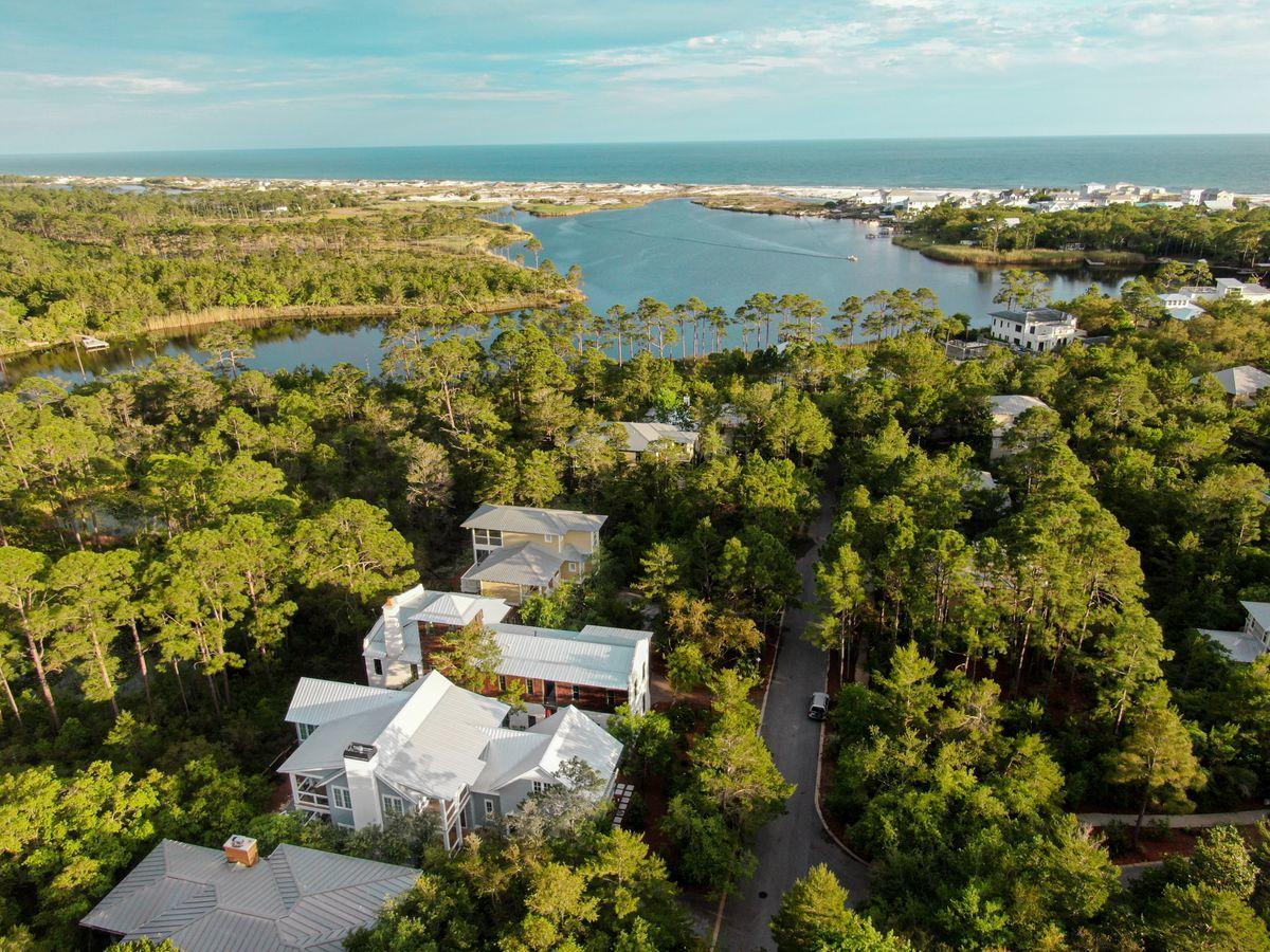 Expertly designed and masterfully crafted, this stunning Hamptons inspired home within the gated community of Lakeplace at Grayton offers privacy, amenities and an unparalleled lifestyle, both inside and out. Spanning nearly 3,500 square feet throughout two spacious levels, with an additional 1,100 square feet of outdoor decking, this Geoff Chick designed home was built with the highest level of craftsmanship by the team at Ryan Harp construction. Featuring breathtaking details such as soaring ceilings across the open concept living spaces and a Chef's kitchen equipped with Sub-Zero appliances and an oversized quartz topped island. The main level of the home also features a guest room with ensuite, a powder bath and laundry with plenty of built in storage. The second floor of this delightful home, completed in 2019, offers an oversized master bedroom with luxurious soaking tub and walk-in closet, as well as two additional bedrooms and a flex space, perfect for a game room, fifth bedroom, home office or second floor living area. A private ensuite pairs with the second floor guest room, while a shared full bath provides access from the fourth bedroom as well as the bonus space for optimal convenience. 


Outdoors, the private pool with sunning deck offers endless fun in the sun, while the large two-car garage ensures additional privacy where it matters. Backing up to the State Park, this iconic location provides amenities such as a community pool as well as community pier, perfect for launching paddle boards and kayaks for your next adventure on Western Lake. Paddle to the beach or enjoy a quick golf cart ride to the sand as well as wonderful boutique shopping, fantastic dining and the nation's number one rated beaches, all within the inspiring artistic community of Grayton beach, Florida.