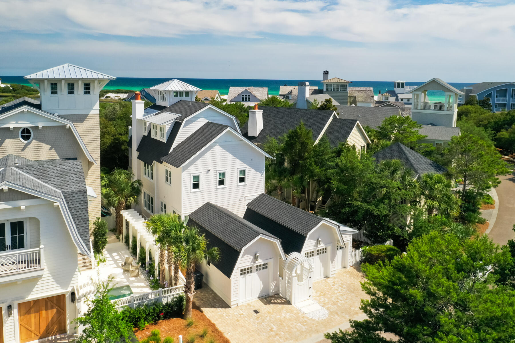 Few homes capture the essence of ultra-luxury coastal elegance as effortlessly as 29 Tidal Bridge Way, a masterpiece nestled in the prestigious WaterSound Beach community along Florida's iconic 30A. This residence, steps from over a mile of gated secluded beach, is a testament to refined design and unparalleled serenity. With a private pool, spa, elevator and garages for two cars plus an LSV, this home anticipates every desire.

Crafted with visionary precision by Stackable + Mracek Design Group and brought to life by the masterful builders at Corestruction, this three-story retreat is a harmonious blend of timeless architecture and contemporary sophistication. From the moment you step inside, impeccable craftsmanship and fine finishes set a tone of understated grandeur.

Spanning nearly 3,300 sq ft with four bedrooms, three full bathrooms, two half baths and a first level flex space, the home is designed for both intimate family moments and grand entertaining. A private elevator seamlessly connects all three floors, ensuring effortless living. The first floor offers three bedrooms and a versatile living space with a kitchenette, evoking the charm of a private carriage house. The second floor is a triumph of open-concept design, where the living, dining, and kitchen areas flow together with effortless grace. The kitchen, a showpiece in its own right, is a chef's dream.  Marble surfaces and backsplash gleam with sophistication, while hand-hewn oak beams lend a warm, grounded elegance. Expansive balconies on every level invite al fresco living, with a summer kitchen off the main living area perfect for sunset soirées.

The third floor is nothing short of a sanctuary. The master suite, crowned by a soaring cupola that floods the space with natural light, is a study in architectural brilliance. The primary bathroom is a haven of indulgence with seamless glass, marble-laden shower and walls, makeup vanity, and a soaking tub that promises serene evenings. Step onto the third-floor balcony, where a two-person chaise lounge awaits an idyllic perch to savor the day's end with exemplary Gulf views.

It's not merely a residence; it's a legacy and a rare opportunity to claim a piece of the Gulf Coast's most coveted coastline. At 29 Tidal Bridge Way, luxury isn't just lived; it's felt, in every thoughtfully designed detail and every breathtaking view. For those who seek the pinnacle of coastal living, this is your invitation to own the extraordinary.