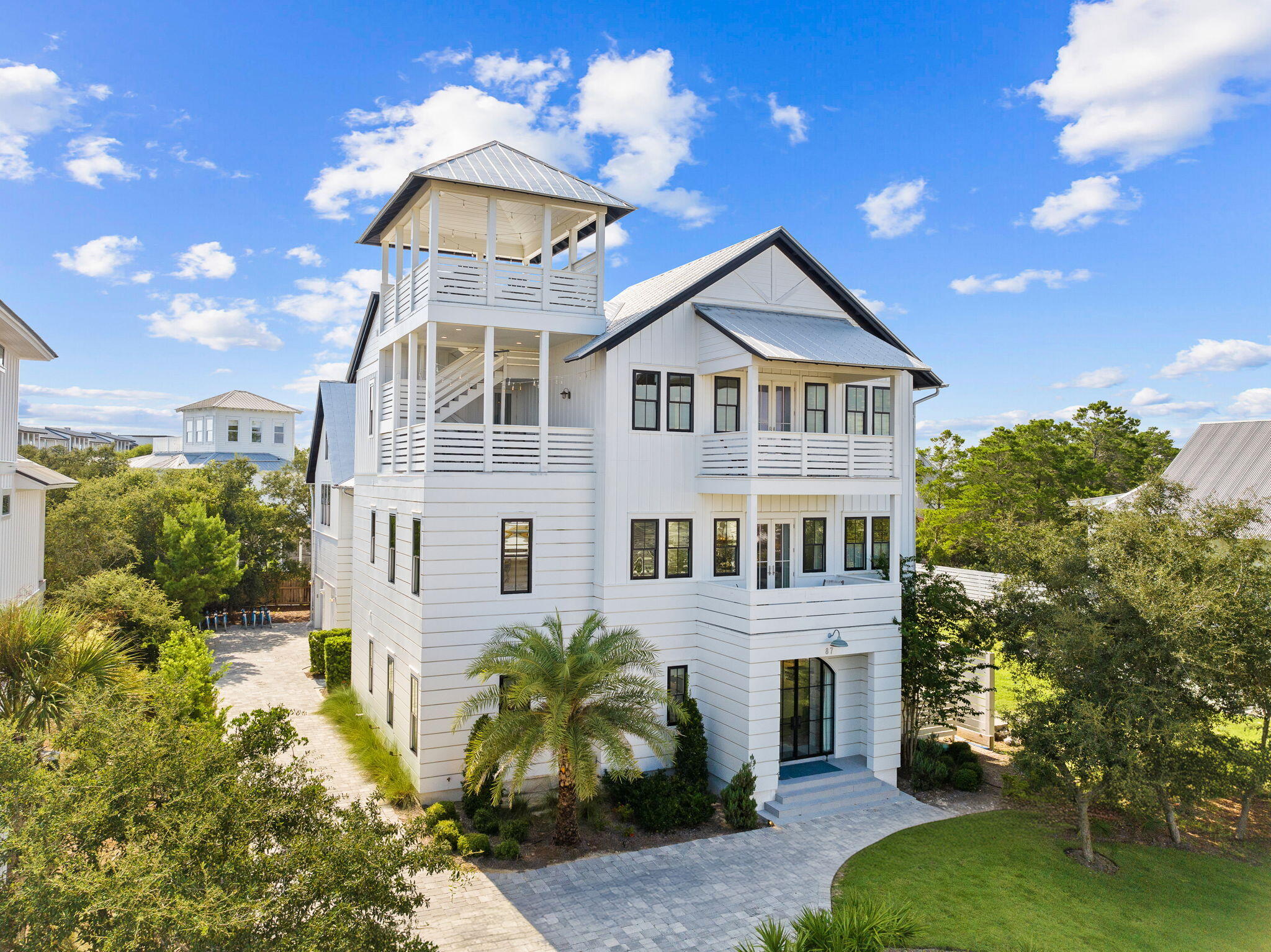 Discover this exquisite custom home on the east end of Scenic Highway 30A in Seacrest Beach, FL. Fully furnished with high-end interiors by the 30A Design Group, this luxurious beach residence offers an expansive lot with an impressive pool deck and generous outdoor living spaces, perfect for enjoying the coastal lifestyle. 

The home features a versatile floor plan with five bedrooms, a bunk room, and a carriage house with an upper loft, providing ample space for large family gatherings or optimizing rental potential. Two spacious master suites make it ideal for accommodating multiple families. Located at 87 Seacrest Drive, this property is perfectly positioned between Alys Beach and WaterSound, with dining, entertainment, and shopping just a short golf cart or bike ride away. With beach access only 1/3 mile from your front door, this home is an exceptional opportunity, whether as a second home or an investment property on 30A.