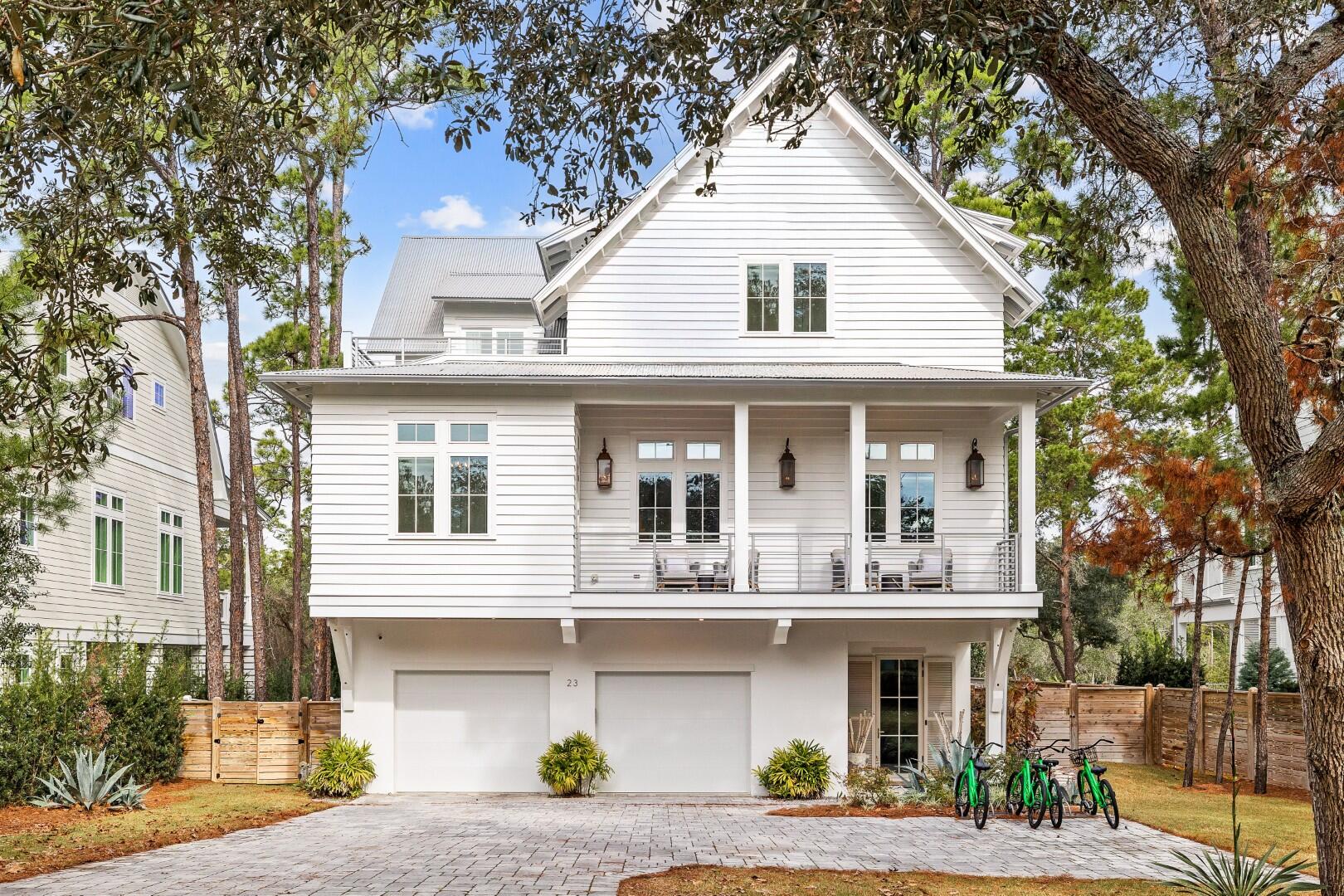 Located in the highly desirable Dune Allen community along Scenic Highway 30A, this fully furnished coastal retreat offers a rare combination of upscale design, flexibility, and strong short-term rental potential - with no HOA restrictions. Whether you're looking for a luxury getaway or a high-performing income property, this one checks all the boxes. 
Set on a private, tree-lined lot, the home features 12-foot ceilings, floor-to-ceiling windows, and a light-filled open layout built for hosting and relaxing. The gourmet kitchen impresses with sleek white waterfall-edge countertops, a 48' dual-fuel range, top-tier built-in appliances, and an oversized island with seating for six. A dedicated home office just off the kitchen is perfect for remote work or quiet retreat.
Designed with comfort and privacy in mind, the home includes two king primary suites - one on the second floor and one on the third - plus two additional king bedrooms and a custom bunk room, each with its own private bath. The third floor also features a flex space, perfect for a media or game room. Three owner's closets provide ample secure storage for personal items.

Just off the second-floor family room, doors open to a large elevated porch with a heated pool, lounge area, and fireplace. Offering the ultimate in outdoor living. In total, the home offers more than 1,000 square feet of porch and patio space, including a ground-level covered living area with a fireplace, an outdoor TV, dining space, and a fully equipped summer kitchen featuring a grill, sink, and mini fridge.

An elevator connects all three levels, and an oversized garage offers ample storage for beach gear, bikes, or golf carts. Ideally located near Gulf Place Town Center, top-tier golf, and the scenic trails of Topsail Hill Preserve State Park, this home offers both convenience and coastal serenity.
