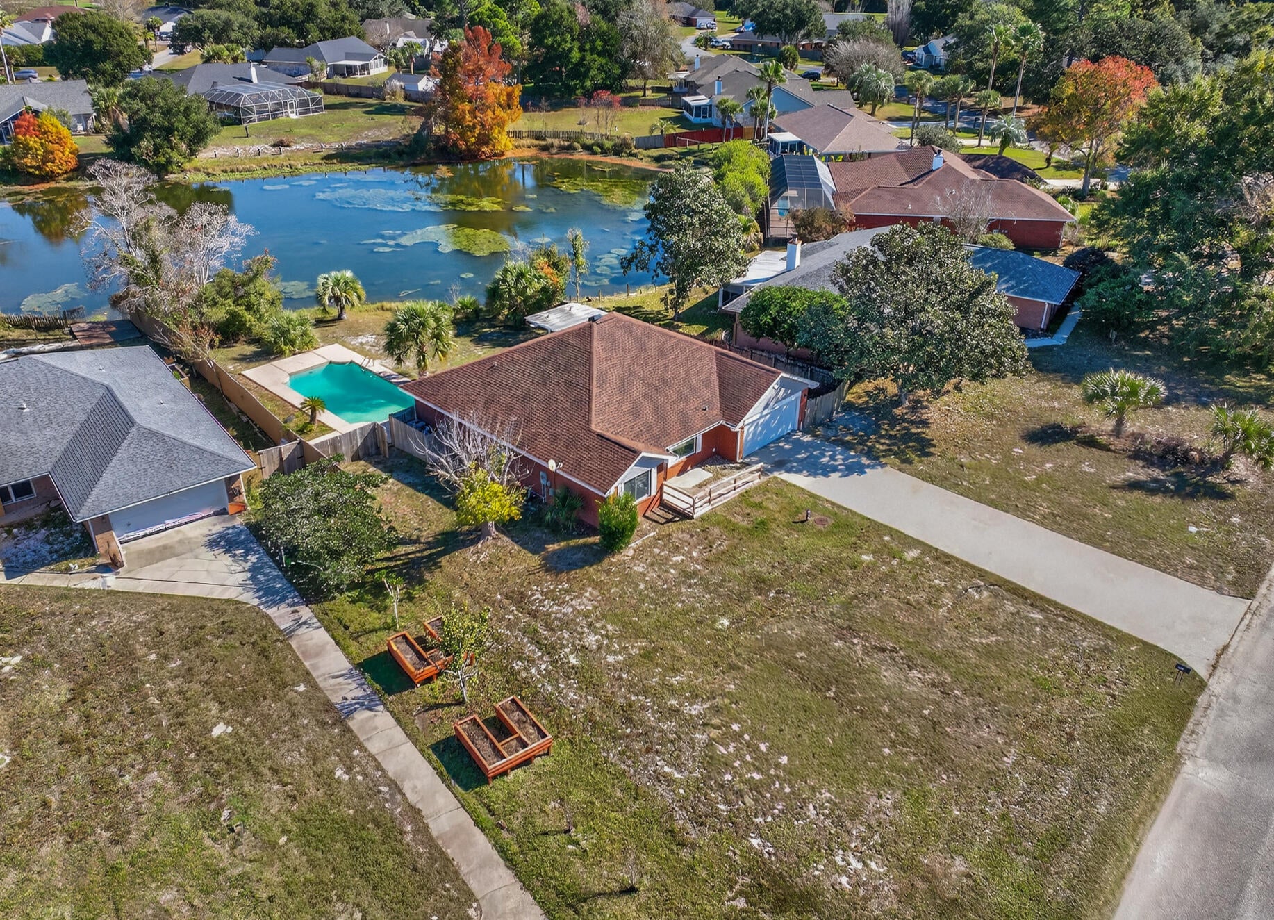 Welcome home to your lakefront pool retreat in Spanish Trace Estates! With low HOA fees, this beautifully refreshed residence offers the perfect blend of modern updates, timeless style, and peaceful waterfront living.

Step inside to find a home that feels light and airy, thanks to recent upgrades including all new major systems, stainless steel appliances, LVP flooring, fresh interior paint, and updated ceiling fans, light fixtures, and matching door hardware. The thoughtful improvements elevate the home's comfort and appeal while maintaining its traditional charm.

Designed with a split floor plan, this 4-bedroom, 2-bathroom home provides both privacy and function. The inviting main living area features high ceilings and flows seamlessly into the open kitchen, complete with granite countertops, ample cabinet space, and a walk-in pantry. A dedicated dining area and a generously sized laundry room off the garage add everyday convenience.

Wake up to serene water views in the primary suite, where French doors offer private backyard access and frame the picturesque lake. The ensuite bathroom includes a double vanity and two walk-in closets, offering plenty of storage and comfort.

Enjoy Florida living at its best in the backyard oasis. Featuring a generous .30 acre lot! Relax under the covered porch, take a refreshing dip in the gunite pool, or entertain guests in the additional yard spaceall while enjoying a peaceful lakefront backdrop.

With its beautiful updates, spacious layout, and stunning outdoor features, this home is ready to welcome you. Schedule your showing today! Roof 2023, Pool Pump 2024, Hurricane Impact Windows 2024, HVAC 2019, and HWH 2018.