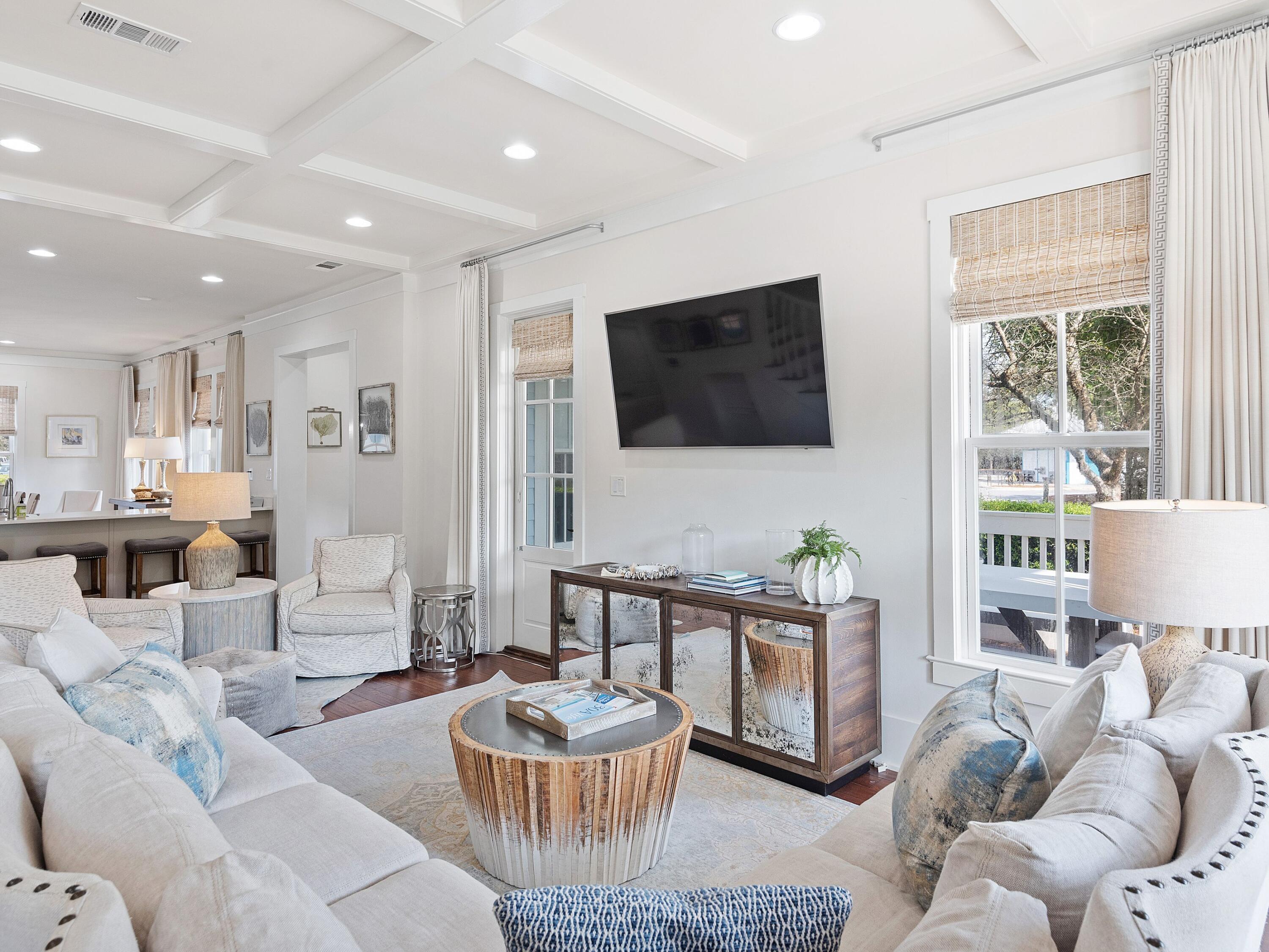 Enviably situated at the intersection of 30A and Western Lake Drive, this desirable WaterColor residence includes a two-car garage with carriage house accommodations and an idyllic private pool with a shady cabana. This elegant home has been beautifully updated including all bathrooms. Beneath the coffered ceilings, you'll find warm-toned hardwood floors, designer furnishings and coastal-inspired decor. The bright and airy living and dining areas provide space for seamless entertaining and relaxing after a day at the nearby white sandy beach. The chef-inspired kitchen wows with Cambrian quartz countertops, commercial-grade Viking appliances, Shaker-style cabinetry and a generous breakfast bar to seat five. Hosts will appreciate the separate wet bar with beverage refrigerator and ice maker. Four bedrooms in the main house include a guest suite and a half bath on the first floor. Climb the stairs to the second floor to find a spacious guest suite with its own private balcony. There's also a bunk room for youngsters and a quiet sitting room/TV den with direct access to the side porch. The serene master bedroom exceeds expectations with three closets, a private balcony and a spa-inspired ensuite. It boasts dual vanities, a deep tub and a large walk-in shower. There's also a laundry room and wet bar/coffee station on the second level. The third-floor tower room provides 360-degree views of the community and the shimmering Gulf of Mexico. A second-floor walk-over connects the main house with the carriage house. It pampers guests with a beautifully appointed bedroom, bathroom, living space, fully equipped kitchen with range/oven, and a Juliet balcony. The incredible outdoor living spaces feature six covered porches, a private swimming pool and a summer kitchen with sink and grill. A pretty trellis shades the lounge area complete with TV and there's a cabana bathroom and outdoor shower. Located on 499 acres of prime gulf-front, the WaterColor community offers all the charm of small-town life. The well-stocked boathouse offers kayaking, canoeing and paddleboarding on Western Lake. Exceptional amenities include six community swimming pools, peaceful nature trails, fitness center, tennis facility, green parks and a lazy river and waterslide at Camp WaterColor. This exceptional luxury home is also conveniently close to WaterColor Beach Club for enjoying the zero-entry pool, sunset terrace and upscale dining.