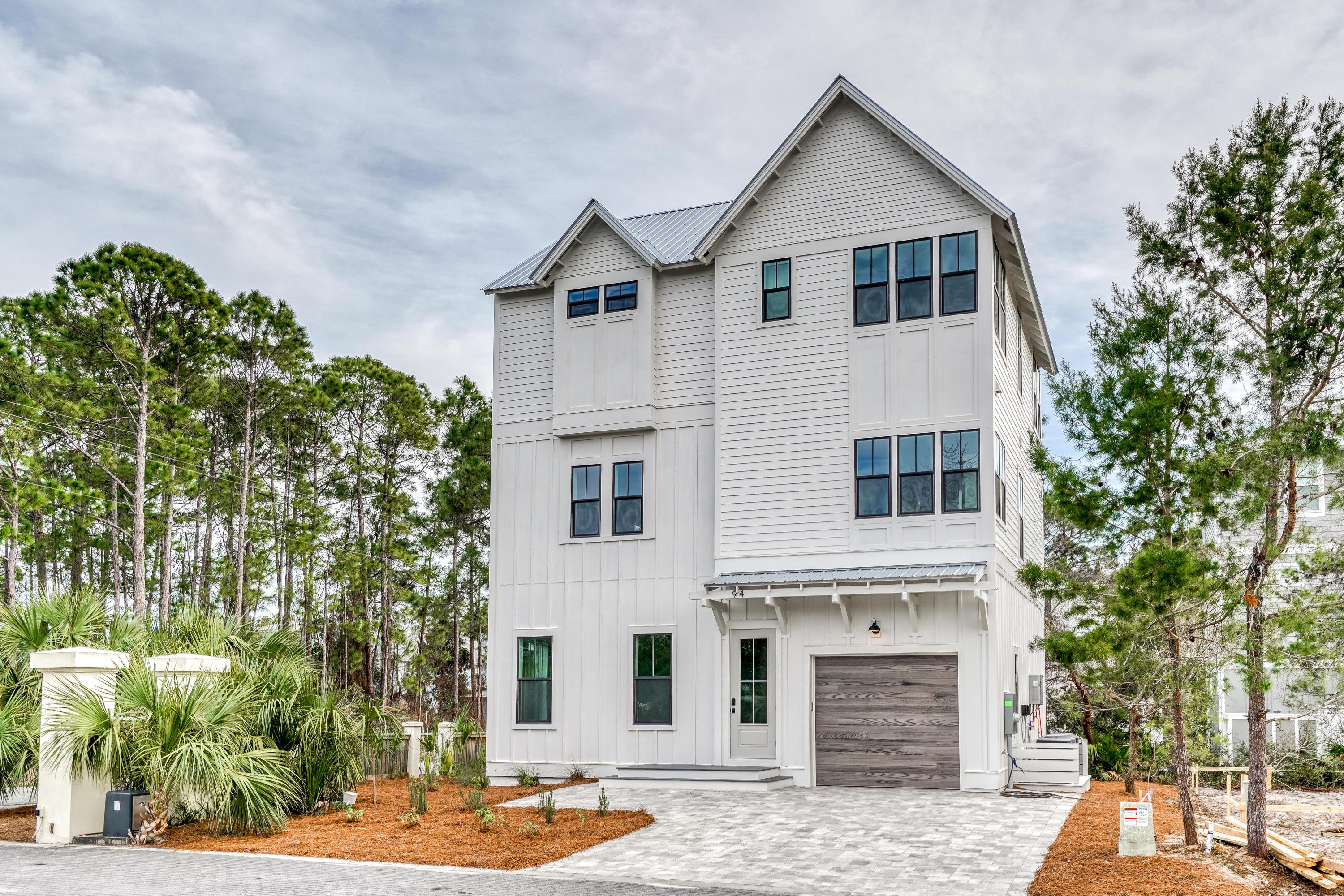 This gorgeous new beach home is located in the quaint community of Cottages at Seagrove, just steps from the sugar white sand and emerald green waters. The house is carefully designed with the greatest attention to detail and the best quality in mind. The layout is perfect for living the relaxed beach lifestyle of 30a. On the first floor there is a 1-car garage, two bedrooms and a full bath. The second floor has a magnificent kitchen with a large island, gas stove, and farm sink which overlooks that large open living area. The third floor has a luxurious master suite and a spacious fourth bedroom with full bath. You can enjoy your evenings sitting on the balcony located off the master suite. There are so many impressive features throughout this custom home, including beautiful pine wood floors, private elevator, large storm rated windows and doors, raised ceilings, designer lighting and plumbing fixtures, and stylish quartz countertops.  The location of the house makes for a great rental, second home, or primary.