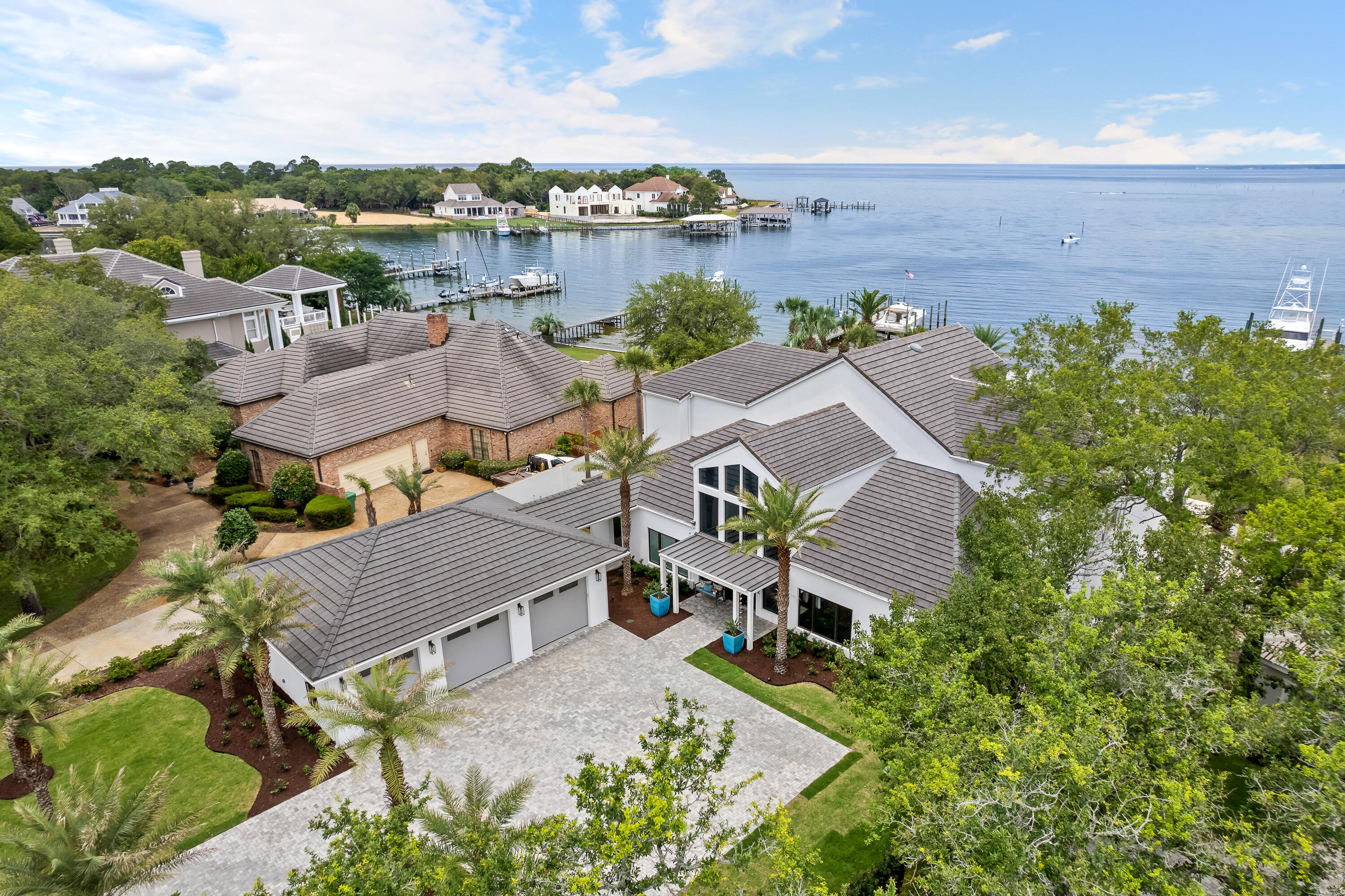 *** Luxury Deepwater Estate ***Located in Indian Bayou with .75 Acres and 138' of scenic waterfront views of the Choctawhatchee Bay. This luxurious home of 6100SF offers over $600,000 of upgrades (2021-2024) to bring this 4bedroom 5 bath a must see! 
Outside the home, a NEW TILE ROOF(March 2024), Leaf Filter Gutter Guards, all New Landscaping including a new front Bermuda Lawn, New Irrigation, New Landscaping Lighting, New paver driveway, a New oversized 3 Car Garage attached by a Breezeway to the main residence, a New 81KW Generac in Home Generator, New Summer Kitchen with Natural Gas Grille, Ice Maker, Refrigerator. For relaxing afternoons or weekend pool parties you will enjoy. Saltwater Heated Pool or relaxing in the Infinity Spa overlooking the scenic views of the bay.
Bring your boating toys, there is a "Trex" dock new in 2019, that has everything available for any size boat. There is 50/30 amp service new in 2022, 40,000LB boat lift that can handle up to a 45' center console boat with new pads, pontoon lift, 2 Jet Ski lifts, and a paddle board or Kayak loading dock. Enjoy a relaxing day with a short ride to Crab Island, or an exciting day fishing in the bay or 15 minute ride to the Gulf of Mexico. 

Living Room/ Dining Room open floor plan offer a panoramic view of the Bay through the wall of windows, custom Built In Cabinets, custom Fireplace, new ceiling fans. A Wet Bar with Miele Expresso Machine, Wine Coolers, dual Refrigerators, and new Ice Maker. There are 6 new Carrier Air Conditioners (2021), new (2)50 Gallon Hot Water Heaters. In the kitchen, new Ice Maker, new Miele Dishwashers (2), new Garbage Disposal, new Faucets, Granite Counter Tops, also includes (2) Sub Zero Custom Refrigerators, Custom Cabinets, new Miele Convection/Microwave, Steamer, and Oven Warmers. The Master Bedroom has new carpet, custom Build in Cabinets, Custom Fireplace and a view of the bay. The large Master Bathroom leads to a His/Hers Dressing Room with custom His/Hers separate closets. On the second floor there are (2) Master size Bedrooms with new carpets, private Bathrooms, and a Washer/Dryer in both rooms. There are private balconies off of each bedroom with  great views of the bay. There is also a media room that can be a fifth bedroom.  There are new ceiling fans in every room through out the house.  

Indian Bayou Community has an 18 Hole Championship Golf Course, a $200/year HOA, and is a short drive to all that Destin has to offer. Boating, Golfing, Beaches, First Class Restaurants, and nightly entertainment at the famous Harbour. Call today for a private showing.