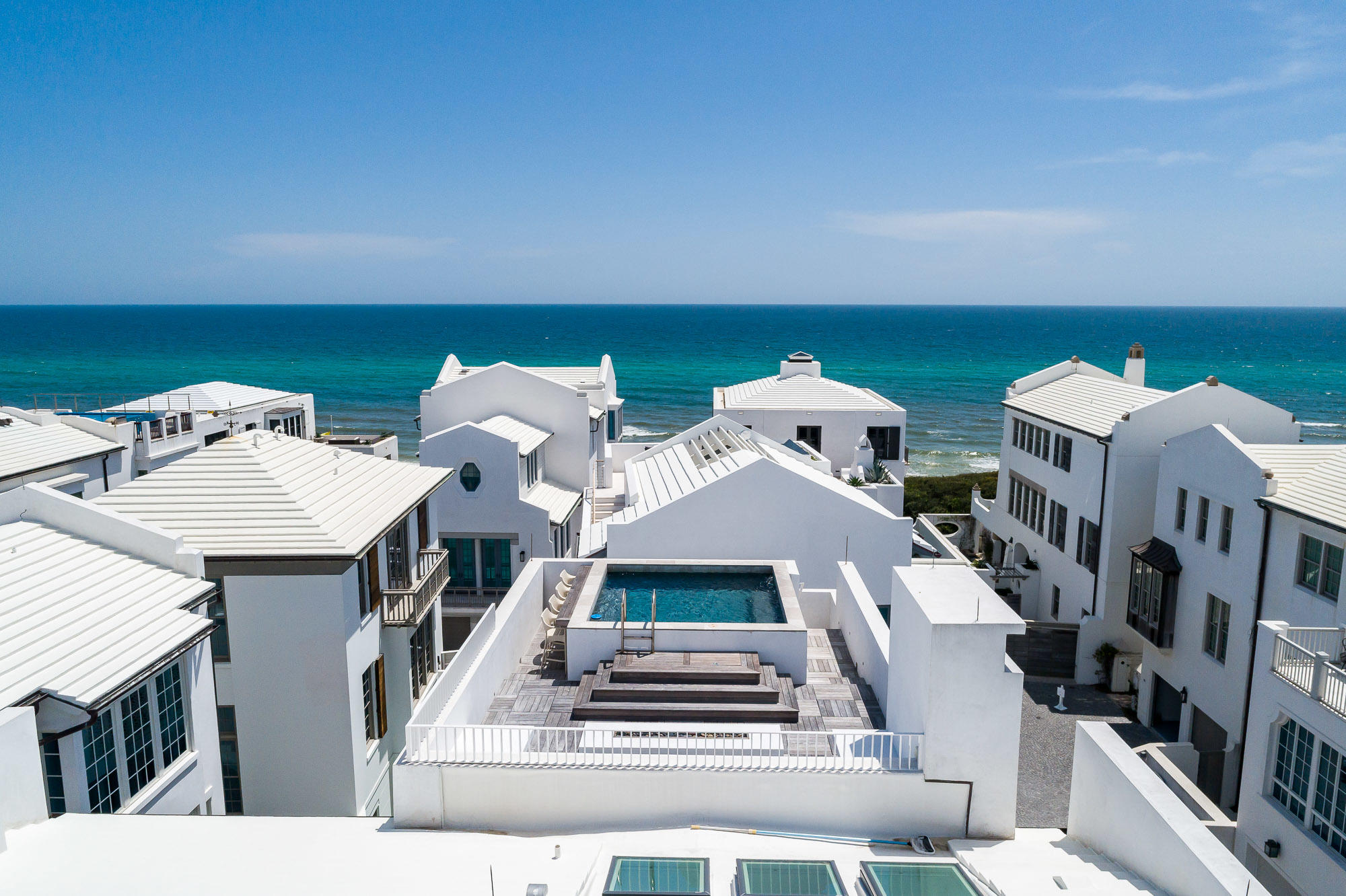 Modern elegance meets the sea. 146 Sea Garden marries exquisite design with the abundance of outdoor & indoor spaces. Upon entering the private entry court you arrive to the sight of the reflective pool centered with a peaceful Olive Tree surrounded by furnishings to relax. The owner created this home closely working with in design by Kennymorrow Architecture and constructed by renowned Galvas Construction with impeccable interiors.
The relationship of indoor space to outdoor living needs to be experienced. The breathtaking courtyards, loggias, and magnificent roof terrace having protected views of the Gulf of Mexico. Whether you prefer the serenity of the first floor courtyard pool or stargazing from the fourth story roof terrace pool for a midnight swim, you will not be disappointed The four bedrooms and bunk room are well placed within the home to maximize privacy with each one.  
Each has its own en-suite......Nothing is repeated from bed to bath in the home.  Distinct tiles & backsplash represent each of the bedroom's character.  Naxos Marble along with Athens Cream Marble are just the start.  Two of the bedrooms are detached, private suites with both having private entry to the living areas of the home.
The first floor entry court is privatized by beautiful reclaimed Swamp Cypress gates for enjoyment of the courtyard loggia and pool.  The first guest suite and bunk bedroom flank the courtyard perfect for visiting guests.
Rising to the second floor via stair or elevator brings you to two additional guest bedrooms and the master suite.  Each bedroom holds its own personality creating uniqueness of all spaces provided.  The master suite holds protected Gulf views from bed to shower.  Lift & Slide doors open for cooling winds provided by southerly Gulf winds when the weather is perfect.  Added value lends itself to the sounds of the waves meeting the shore.   
The awe-inspiring third floor is breathtaking to say the least. Kitchen, living, dining, & the Sea Loggia occupy the entire floor. Skylights above the kitchen island offer natural light and architectural kinship to the ambiance.  The fireplace provides warmth to the entire space.
Lift & Slide doors open east to west through the main living area allowing for the cool Gulf breezes to pass through the home exiting to the Sea Loggia where you will find an enchanting outdoor fireplace and summer kitchen.  The Sea Loggia is located steps from the kitchen allowing for ease of transportation from the Scullery prep room to the summer kitchen.  
The gourmet kitchen further enhances the home's atmosphere & entertaining capabilities.  From the kitchens scullery to the summer kitchen of the main living area outdoor loggia you can dine in the open air while watching the sun set over the Gulf of Mexico.  The Scullery's Thermador double-oven with prep station is perfect for the private chef's creation for you & your guests.  
You feel the home is complete until you find the fourth floor furnished roof top terrace with heated pool looking over the horizon of the emerald waters of the Gulf of Mexico.  Sunsets, star-gazing, and viewing of the occasional meteor showers punctuate the perfectness of this incredible home.  
Details were not spared from the architectural design to the finishes of the home.  Control lighting and entertainment from the touch of your smart phone.  Powered sun shades react to one touch to tame the afternoon sunlight if desired.  
Reclaimed Swamp Cypress warms the exterior elevation and outdoor living areas of the home yet still characterizing modern living.