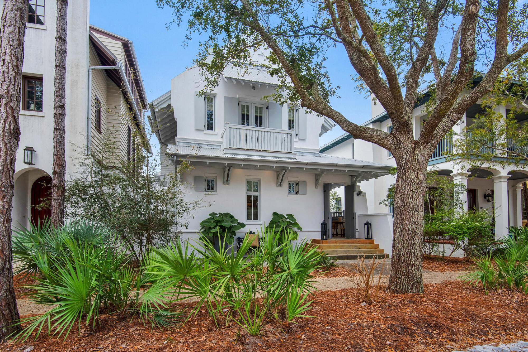 This extravagant Rosemary Beach home goes beyond expectations to deliver a magnificent main cottage and carriage house that could rent separately when not in use. Recent designer updates and renovations have resulted in a luxury home of character that's move-in ready. Broad steps invite you inside where white shiplap walls , soaring vaulted ceilings, exposed iron structural elements and wood beams provide a contemporary living space with a playful ambiance. The Italian-inspired kitchen has a new dual fuel ILVE gas range, 2-tone custom cabinets and custom plaster hood, creating a gourmet kitchen to inspire any keen cook or entertainer. A beverage center and wine chiller ensure that hot and cold drinks are always ready to serve at the pristine island bar. The family-friendly floor plan includes an open dining area, two living/entertaining areas, a first-floor master suite and a SONOS sound system throughout. Upstairs provides a second master suite, which boasts cathedral ceilings, a marble bathroom with a Japanese tub and a private balcony overlooking leafy park views. An additional guest room and adjoining bunk room graciously accommodate additional guests. Wander outside and check out the outdoor kitchen in the private courtyard that connects the two homes. There's a delightful sitting area for social gatherings beneath a shady pergola. The carriage house sits above the garage. It was stripped back to the studs and now boasts a luxurious bathroom, sleeping area with solarium, dining nook and kitchenette. Raised beamed ceilings accentuate the sense of light and space. Perfectly positioned on a quiet street in Rosemary Beach facing a trellis-lined park, this immaculate home has the best of both worlds. It's a short stroll from the private pool and cabanas at the exclusive owners' club and a stone's throw from all the excitement of Rosemary Beach Town Center.