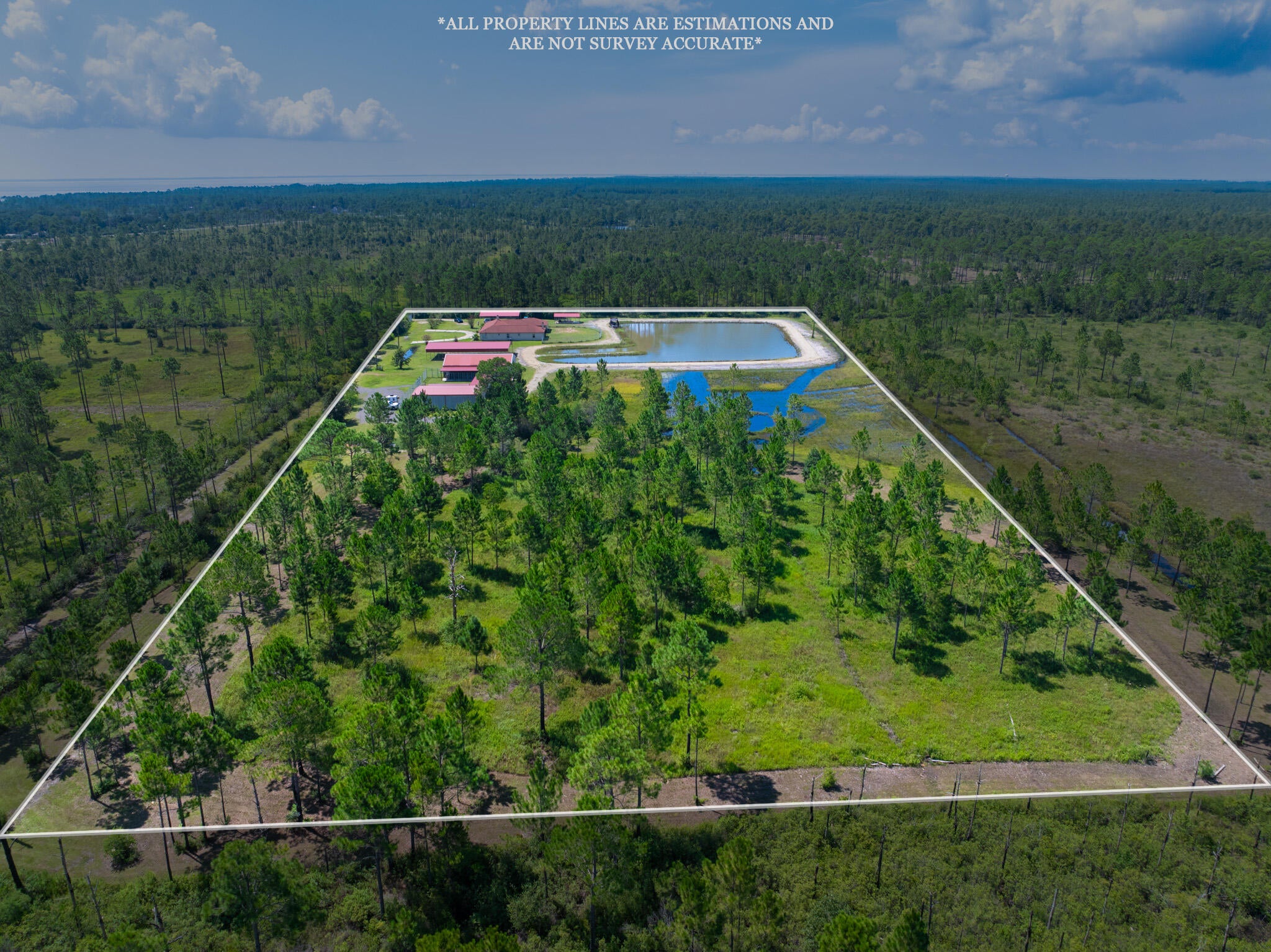 NEW ROOF to be installed prior to closing. 

If you're a horse lover, dog trainer, or passionate about wildlife, your search for a peaceful country haven ends here! Enjoy the best of both worlds with this beautiful 9.996 acre  property located just  20 minutes from shopping and stunning beaches. 

Welcome to this 2,284  sq. ft.  home featuring 3 bedrooms and 3.5 bathrooms. ALL BEDROOMS EQUIPPED WITH PRIVATE  FULL BATHROOM.  

The cozy 2 sided wood-burning fireplace can be enjoyed from both the living room and the kitchen. Spacious primary suite offers its own wood-burning fireplace, a large custom closet and an en suite bathroom featuring a separate tub and shower with double vanity and tile flooring.

Step outside to enjoy the one-acre pond, perfect for leisurely strolls or simply soaking in breathtaking sunsets.

This property is equipped with a private well with a water filtration system and 2 septic tanks, helping maintain lower utility bills.

You'll also appreciate the three-car garage and ample outdoor parking/storage.
The property features 3 metal carports , one being 30x60 with 14-foot ceilings - perfect for RV parking. A 30'x50' barn that can be converted back to its original equestrian use.

Impressive 40'x60' insulated metal building with roll down door and 1/2 bath offering versatile options for your hobbies or business needs. Both barn and the large metal shop are equipped with separate utility poles.

With so much to offer, this country retreat perfectly balances spacious living and outdoor enjoyment, all while being zoned for agriculture. This means you can pursue your passion for farming or equestrian activities right from your doorstep. Don't miss the opportunity to make this tranquil haven your forever home!
