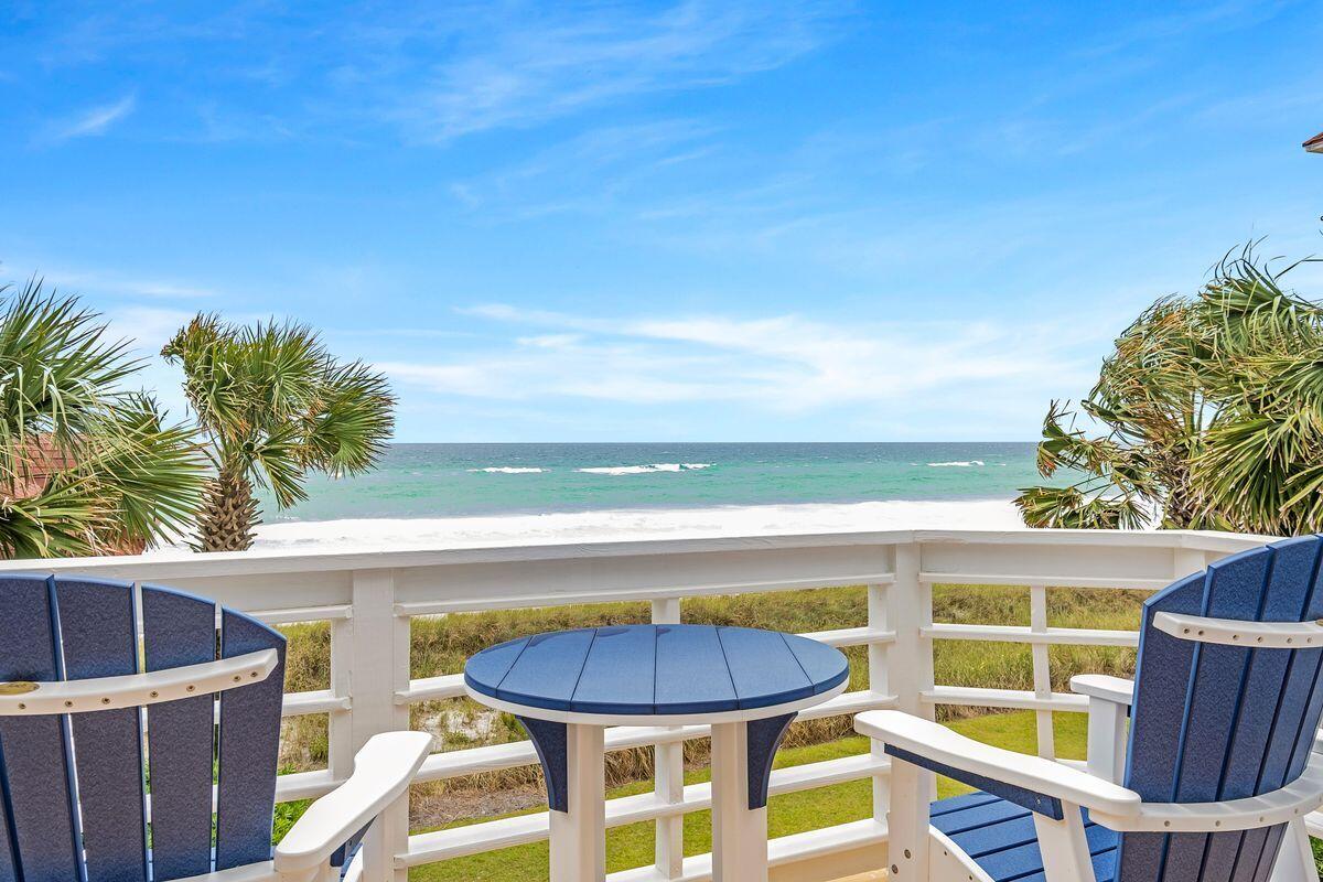 For anyone serious about living on the beach, this three-story gulf-front home does it in grand style. Set back behind a low picket fence, the first-floor terrace overlooks the grassy yard, white sand dunes and glittering blue water. The breathtaking gulf views get even more panoramic from the upper balconies. Imagine awakening to the gentle sound of the sea as you step out onto the balcony from the second-floor master bedroom to greet each new day. The suite includes an en suite with twin vanities, large shower and separate jetted tub. The third floor is reserved for the uber-spacious master suite with wall-mounted TV, very private balcony and sleek bathroom with shower, double vanities and another jetted tub. The first floor has the main living area with feature fireplace and practical wood flooring throughout. It flows seamlessly out onto the covered screened porch. Sip coffee at the counter on the back deck and watch the sunrise. Entertaining is easy with a fully equipped kitchen, breakfast nook and a formal dining area. Outside, rustle up surf and turf at the grilling station while admiring yet more gulf views. Guests can make use of the bunk room or enjoy their own private space in the detached carriage house above the two-car garage. The one-bedroom guest house sleeps four and includes a kitchenette, full bath and living area with sleeper sofa. The property includes a 20'x8' courtyard pool. This dream beach house is located in the gated community of Shipwatch which has 400 feet of private beachfront. It's ideal as a second home or income generator. Projected gross annual rental income of $300,000+ can easily be achieved due to the superb location close to everything. Enjoy walking or biking along Scenic 98 to restaurants, the outlet mall, Grand Boulevard or your favorite breakfast spot.