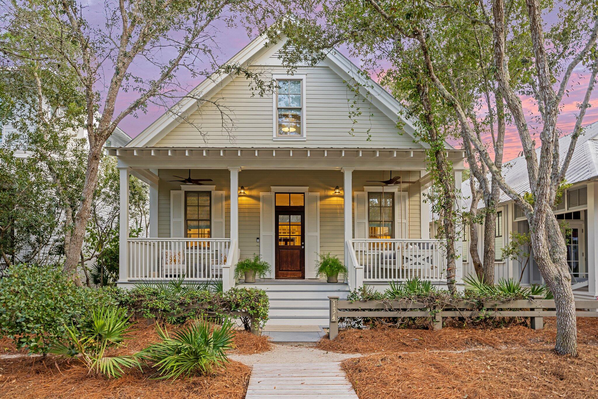 This pretty Florida Cottage oozes curb appeal, from the easy-to-maintain landscaping to the quintessential front and rear porches. Step through the wooden front door to find a bright, updated home that combines chic modernity with relaxed coastal charm. Hardwood plank flooring creates a natural flow from the sitting area to the dining space with its stylish new chandelier. New light fixtures and windows on either side deliver abundant natural light. The remodeled kitchen has white Shaker-style cabinets, open display shelving and new Caesarstone quartz countertops. It has a useful butcher block center island housing the microwave. Recent additions include a new dishwasher, sink with disposal and a range hood. The generous breakfast bar provides a hub for social chatter and snacks. The rear hallway makes good use of space with a built-in office nook. Pass a half-bath and a laundry closet with stacked washer and dryer en route to the rear screened porch. Three bedrooms are complemented by additional space in the loft. It offers extra space for sleeping or being used as a cozy sitting nook for reading or for kids to play. The first-floor master suite has an updated bathroom with a twin vanity and oversized tiled shower. It has direct access to the rear porch with ample space for lounging and leisurely dining. Two additional ensuite bedrooms are tucked beneath the eaves on the second floor. The fenced rear yard has a paved patio for barbecues and stargazing while hanging out around the fire pit. There's a newly paved parking pad and enough exterior space for a pool or carriage house for those who want to expand. Offered fully furnished, this charming cottage has a renovated primary bathroom, remodeled upstairs bathrooms, interior paint in 2022 and new outdoor ceiling fans. Current rental projections of $165,000 could be significantly increased to more than $200,000 with the addition of a pool. Located in the highly desirable Park District of WaterColor's Phase I, this home is just steps from the beach club, fully stocked boathouse, Camp WaterColor and Seaside, Florida's, Central Square. It offers easy access to the best amenities along 30A, along with community pools, tennis courts, boardwalks and green spaces closer to home.