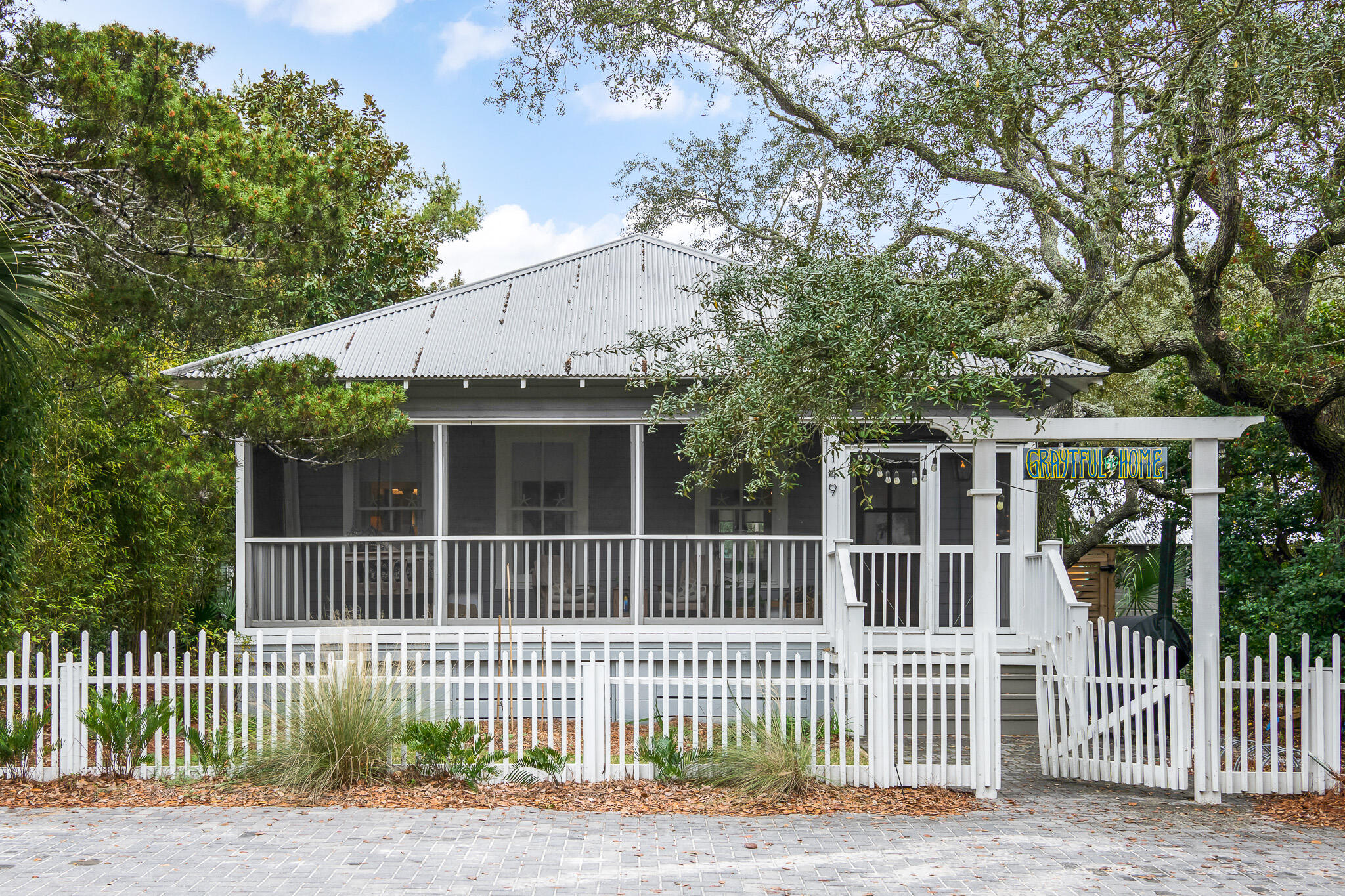 With an unrivaled location in the heart of historic Grayton Beach, this 3 bedroom, 3 full bathroom updated beach bungalow is just one block from the beach. Situated on a highly coveted extra-large lot and framed by century-old live oak trees, this home is a private oasis in the heart of town. Walk out your front door and the best of Grayton is steps away – dining, shopping, entertainment, the always-calm Western Lake, and beautiful Grayton Beach, twice voted the best beach in the United States.

 

If people-watching is your thing, then you'll love the front porch at 149 Garfield. The screened porch is perfect for intimate gatherings, connecting with your neighbors, enjoying your favorite book, or just downtime. Kick back in the swing, enjoy a glass of lemonade, coffee, or your favorite beverage and take a step back in time.

For more intimate gatherings, head to the oversized backyard with its saltwater pool and lush vegetation. This is a perfect spot for family gatherings, pool parties, and barbeques. The backyard also houses a storage shed and is protected by a large privacy fence with a gate, allowing parking for several vehicles and room for a boat or RV. The size of the lot also allows ample room to expand the house or add a garage apartment. (Plans have been drawn by Matt Savoie of Savoie Architects).

Houses in Grayton Beach are a rare commodity. This home provides a laid back life-style in a perfect location. It won't last.