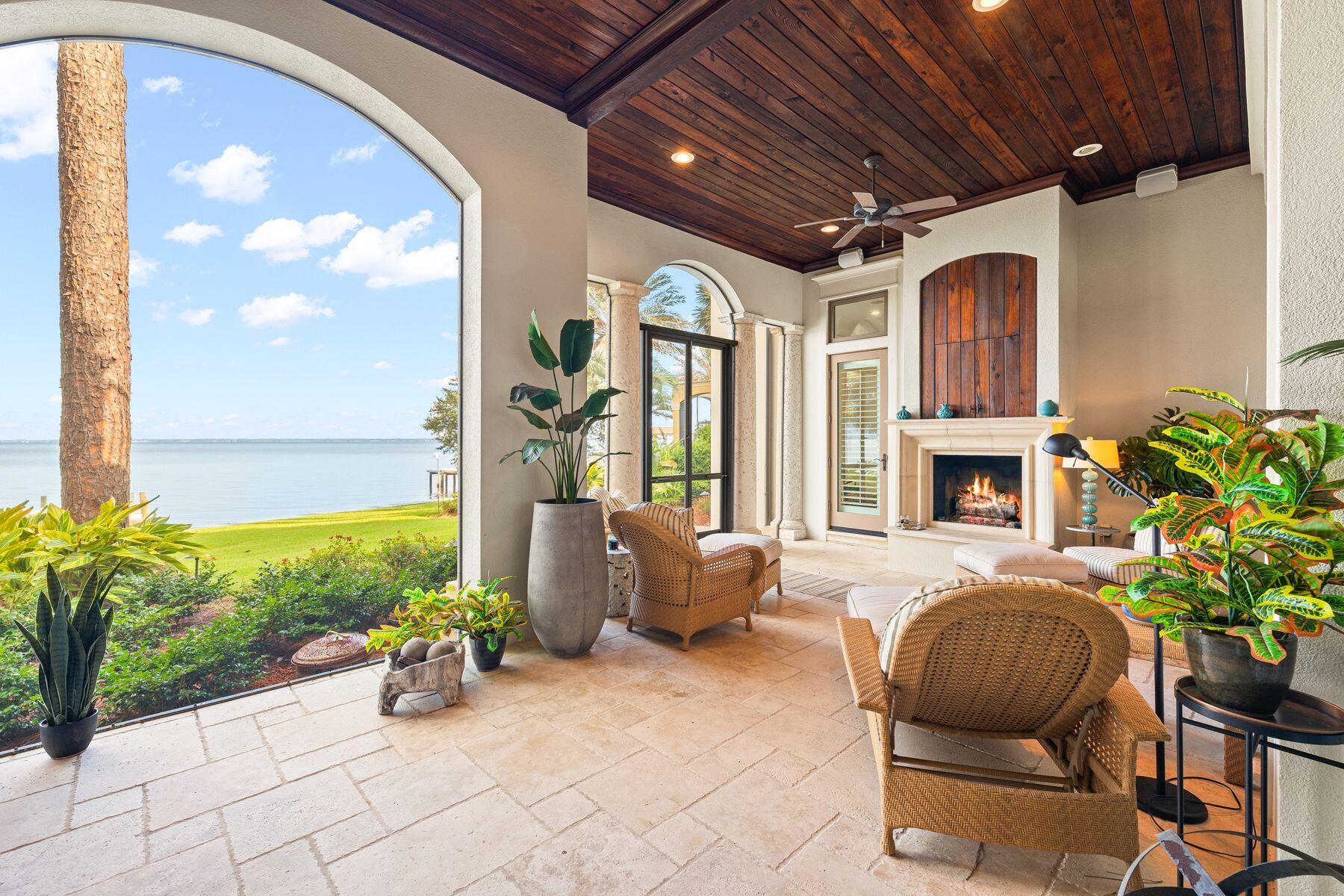 Spectacular sunsets and unsurpassed bay views are all part of this magnificent residence in the exclusive gated neighborhood of Burnt Pine. The home has been superbly maintained with the professional services of a home manager and Housekeeper. The opulent foyer makes a magnificent opening statement with Tuscan-style pillars, travertine flooring, chandelier lighting and a painted ceiling above the staircase. The hall opens into a great room, which is amply spacious for effortless entertaining beneath the beamed ceiling. The chateau-sized fireplace creates a homely ambiance, but it's the bay views through full-height transom windows that steal the show. Sliding doors open into a screened porch with a second fireplace and arched loggia framing panoramic bay views. Step out into the west- facing landscaped paradise of lush greenery and palm trees. It leads down to the new dock with views to Mid-Bay Bridge. The open kitchen includes everything a creative chef or host desires. Endless granite counters extend to a breakfast bar with stools while bespoke cabinetry neatly disguises a full range of gourmet branded appliances. The center island and recessed cocktail bar with ice-maker complement a butler's pantry with wine refrigerator. The elegant wooden dresser is perfect for displaying treasured china and glassware. Through the laundry room, there's access to the three-car garage which has ample space for kayaks, paddleboards and a golf cart too. A hallway leads to a master suite which includes a tranquil sitting area in the bay window. Where better to gently start each day sipping a steaming cup of coffee? The wood-lined elevator whisks guest to the upper floors which boast a large porch for sunset drinks and four further bedrooms including a second master suite with reading nook. Guests will be treated to an upscale boutique hotel experience with lavish spa bathrooms and a handy coffee bar on the second floor. The third-floor office space has a wet bar and more breathtaking bay vistas. As well as having your own watersports paradise for boats, paddleboards and jet skis, owners have access to endless amenities within Sandestin Golf and Beach Resort. Golf, fishing, shopping, entertainment and upscale dining are all part of the Burnt Pine lifestyle.