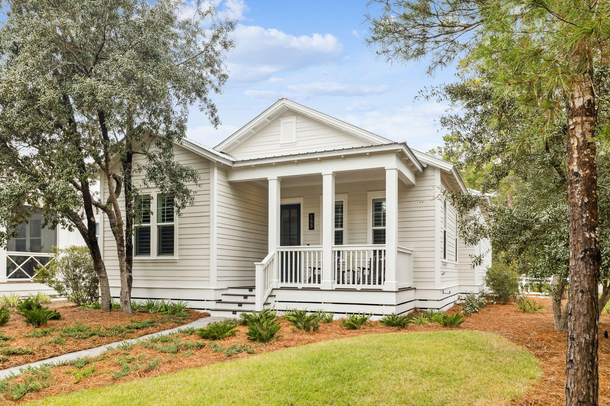 Located just north of Grayton Beach in the quiet bayside community of Grayton Bayou, this single-story, three-bedroom home with attached garage sits on a desirable corner lot and is thoughtfully designed with clean lines, abundant natural light, and refined coastal sensibility. Engineered hardwood floors, 10-foot ceilings, and plantation shutters span the interior. The open living and kitchen areas feature a fireplace, Monogram appliances, gas cooktop, quartz countertops, walk-in pantry, custom millwork and shiplap detailing. A dedicated office provides flexible workspace and could also serve as a fourth bedroom. The primary suite includes a spacious en-suite bath, while two additional bedrooms share a Jack-and-Jill bath. A third full bath adds convenience for family and guests.  Outdoor living includes professional landscaping and uplighting, a screened porch, and a private fenced courtyard. Additional rear parking complements the garage. Residents enjoy low HOA fees, no short-term rentals, a community pool, public boat launch, bay access, and proximity to Point Washington State Forest and Scenic Highway 30A.