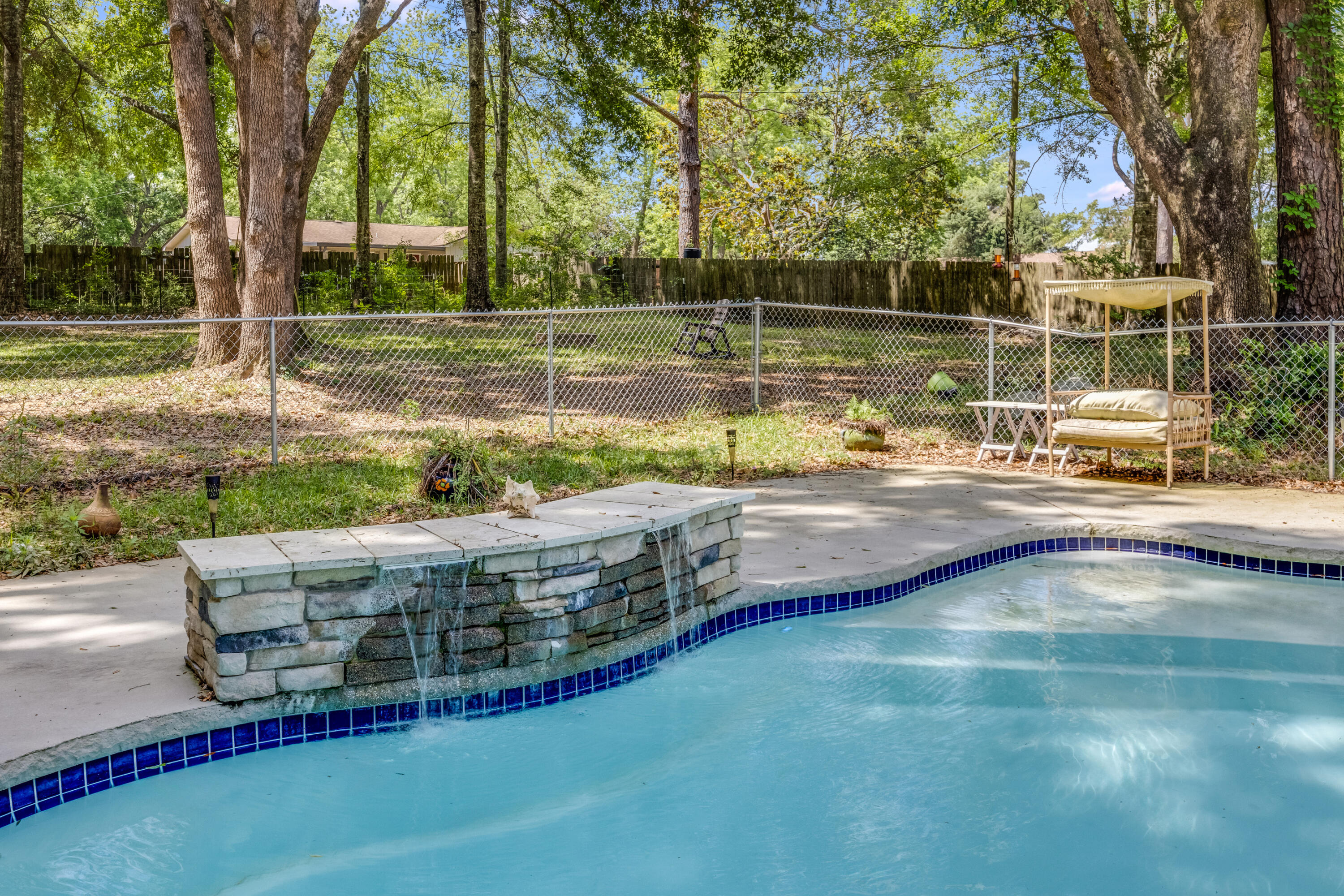 Seller offering $10K credit to Buyer at closing. IN-GROUND POOL, BONUS ROOM and PAID-OFF SOLAR PANELS. Sitting on over an acre, this updated property features modern finishes throughout, including new luxury vinyl plank flooring. The spacious primary suite offers a whirlpool tub and a separate stand-up shower. The kitchen features a breakfast bar, stainless steel appliances, granite countertops and plenty of cabinet space. The living room boasts an open-concept layout with plenty of natural light. Enjoy your private backyard oasis with a sparkling pool with heater and chiller, and a detached shed, perfect for storage or a workshop. Located just minutes from future Costco site, Beulah Middle School, Publix, Wawa, and the Navy Federal Recreation Center.