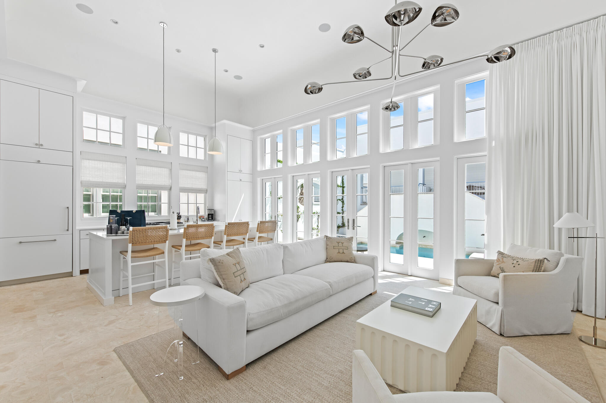 26 North Sea Garden is a recently completed 4 bedroom single family Alys Beach home designed by Khoury Vogt Architects and built by Alys Beach Construction. This residence offers highly sought features in Alys Beach... first floor master suite, two car garage and an expansive private courtyard with dipping pool. 
A large great room spans the width of the site and offers a 16-foot tall ceiling which adds scale and grandeur. This great room, composed of a gracious living room and kitchen with an alcove dining area, opens out to the private courtyard with dipping pool. 
A covered loggia looks out on the courtyard and fronts a detached guest suite, both raised above the enclosed two car garage. The master suite with generous windows opening to the street below is located on the main living floor, and two additional bedrooms, each with en-suite bathrooms are offered on the second floor of the main house.
House is being sold fully furnished with professionally designed interior furnishings and art.