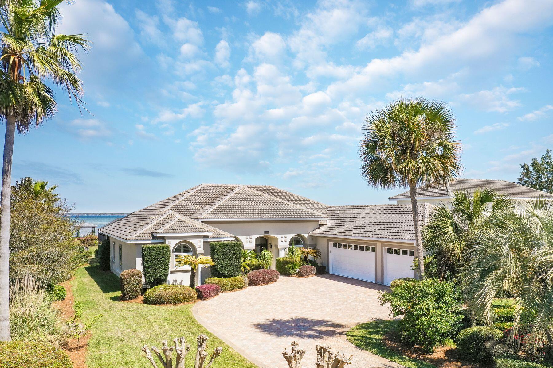 Encapsulating more than 90-pristine-feet on the Choctawhatchee Bay, this breathtakingly remastered waterfront home crafts an undeniable opportunity for contemporary coastal living and absolute privacy thanks to its seclusion within the gated community of Emerald Bay. Each detail of the interior has been hand selected to craft a stunning experience within the more than 3,000 square foot home including waterfall Calcutta Ultra quartz countertops in the chef's kitchen, shiplap walls throughout the living spaces and wide plank flooring in the living, kitchen, and bedrooms areas. 

Re-crafting the interior spaces in order to create an optimal single level floor plan, the new open concept layout invigorates the modernity of the compound style home, offering four full bedrooms, three full bathrooms and an expansive outdoor living space, wrapped around the fully screened in outdoor pool and lanai. Each of the three baths offer unique and discerning styling, capitalizing on clean contemporary influence and a tantalizing mixture of cool and warm tones and furnishings to give life and creativity to each private space. 

The master suite was re-imagined to provide a locale of solace and luxe relaxation with french doors leading to the lanai, gifting endless Bay views and plentiful sunshine. The master en suite is a case study in elegance thanks to the freestanding tub, marble walk-in shower and shiplap walls. Additional details seen showcased throughout the home include a rare three-car garage, brand new lighting and ceiling-fans throughout, as well as a pristinely manicured 0.57 Acre fully sodded parcel. 

Boaters and water lovers will rejoice thanks to the elongated private pier with dual boat slips with lifts, each fully covered. An elegant brick paver pathway leads all who spend time within this property directly from the outdoor entertainment space to the enchanting bay waters, ensuring a truly remarkable experience that is ideal for both full time living and those in search of the perfect second home in a charming golf course community.